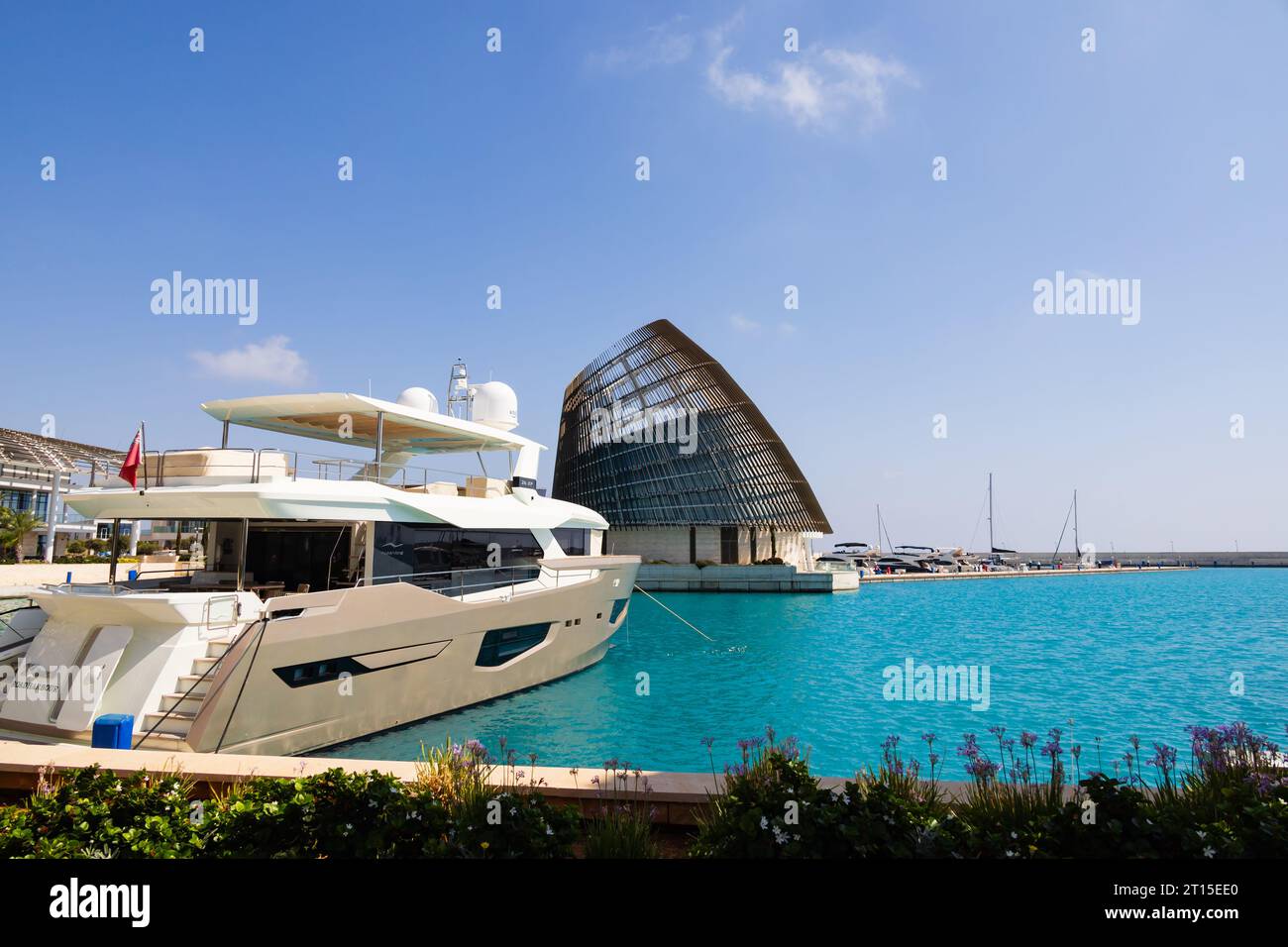 Luxury Numarine 26XP cabin cruiser moored in Ayia Napa Marina with the Event Centre on Festival Pier. Cyprus Stock Photo