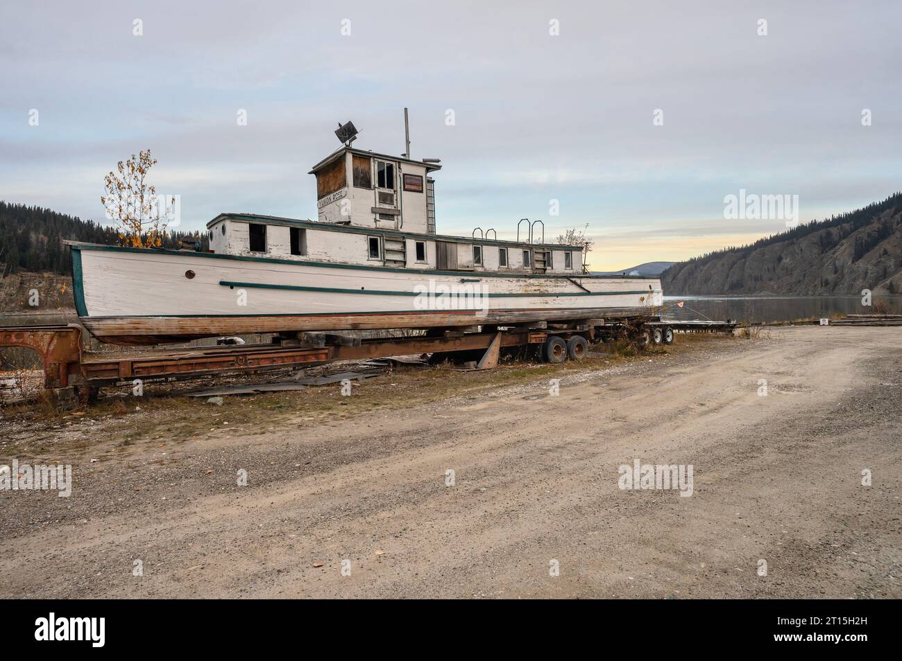 Old river boat (Yukon Rose) on a trailer beside the Yukon River at Dawson City, Yukon, Canada Stock Photo