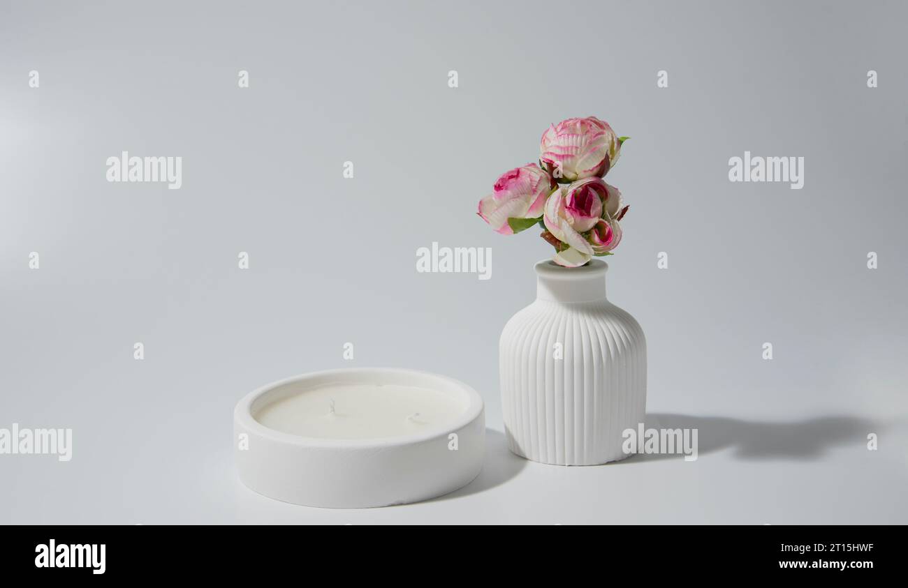 candle in white ceramic pot on a white background ,a vase with a candle.Cozy home natural eco decor Stock Photo
