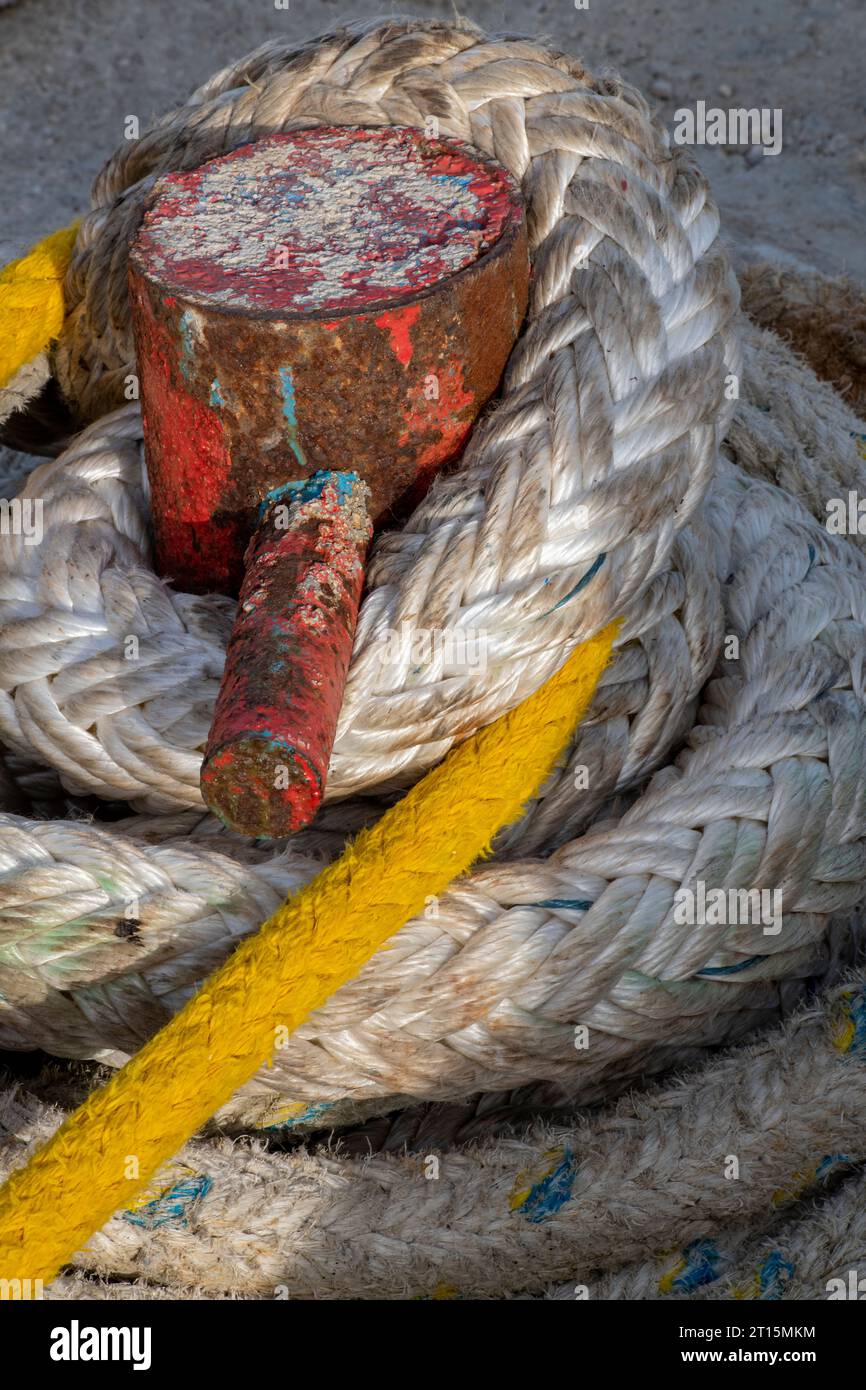 old ships mooring ropes on a bollard at a harbour or port. marine or