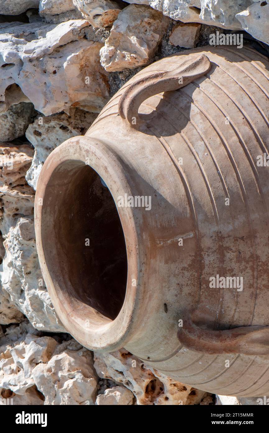 old terracotta greek olive oil storage jar. antique olive oil or wine container jar Stock Photo