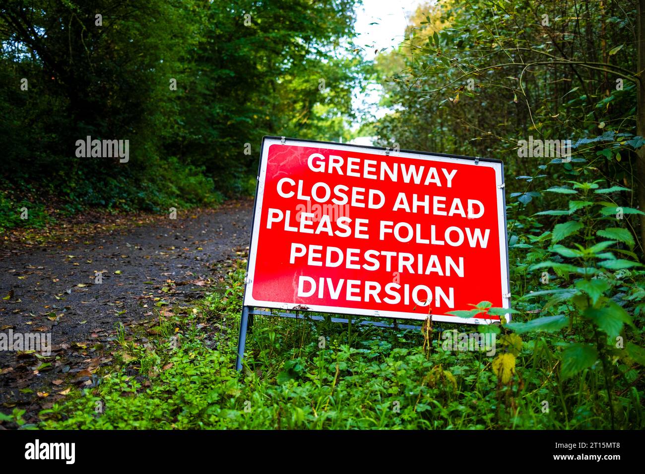 warning sign that the footpath is closed ahead pedestrians to follow a diversion, Salford greenway Roe Green Worsley Stock Photo