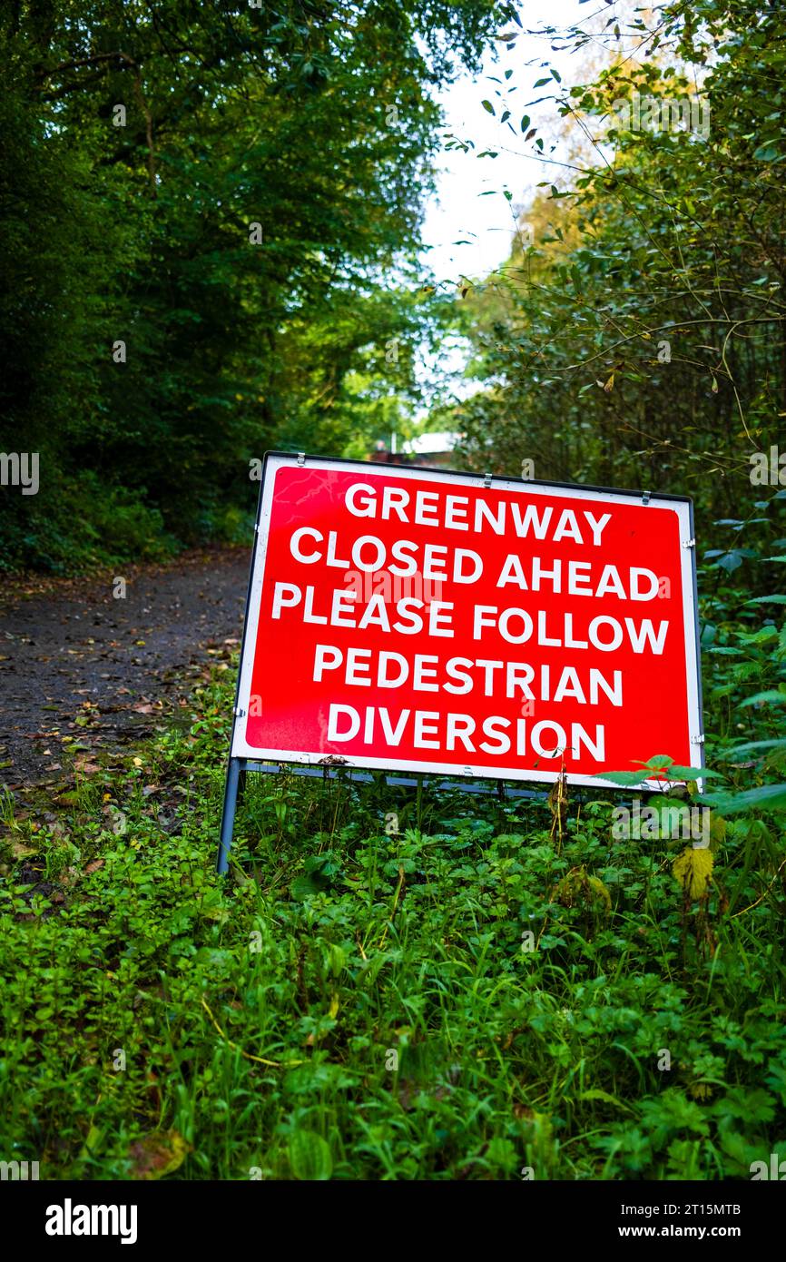 warning sign that the footpath is closed ahead pedestrians to follow a diversion, Salford greenway Roe Green Worsley Stock Photo