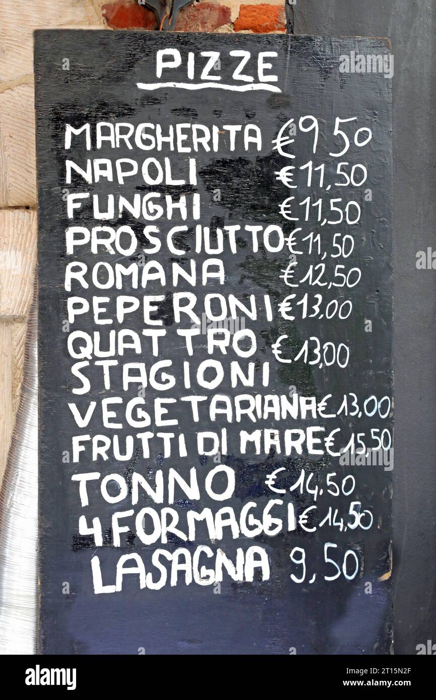 pizzeria board with the list of all the pizzas with the many flavors written in Italian and the price in euros Stock Photo