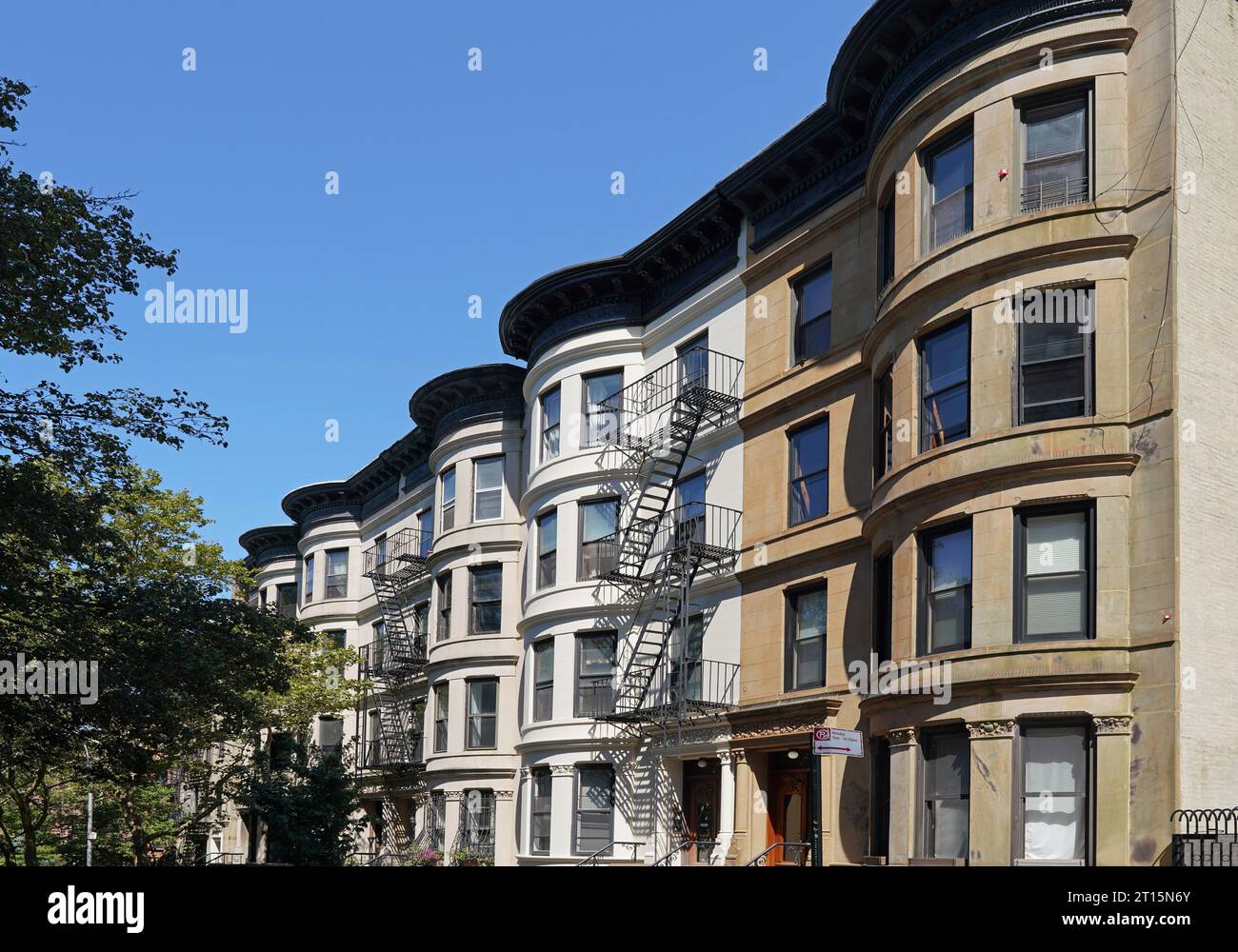 Street of old fashioned townhouses in New York City with curved fronts Stock Photo