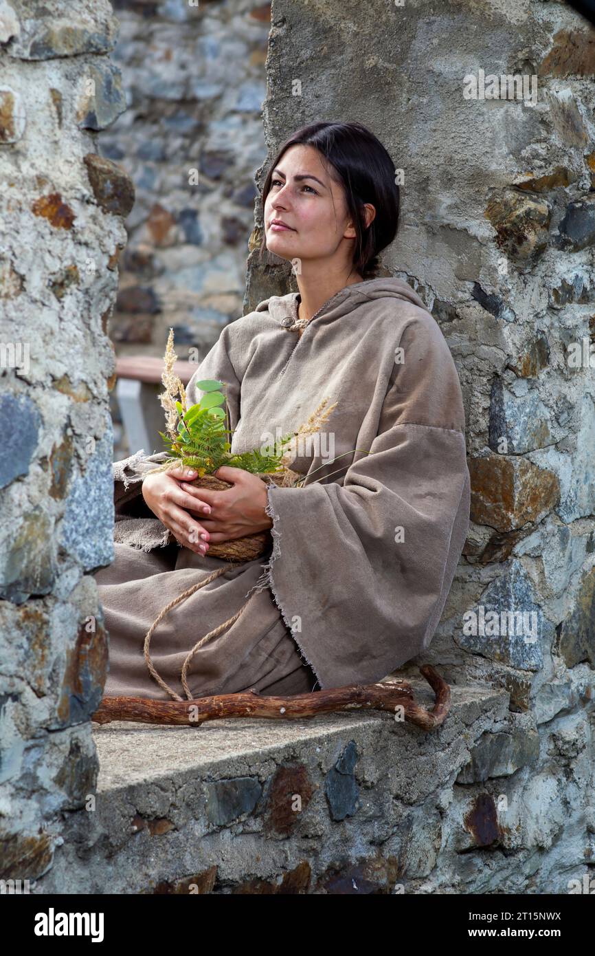 Young poor nature girl in middle age looks thoughtful Stock Photo