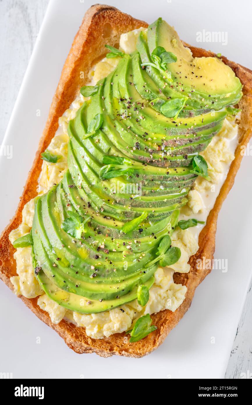 Sandwich with ciabatta, scrambled eggs and avocado Stock Photo