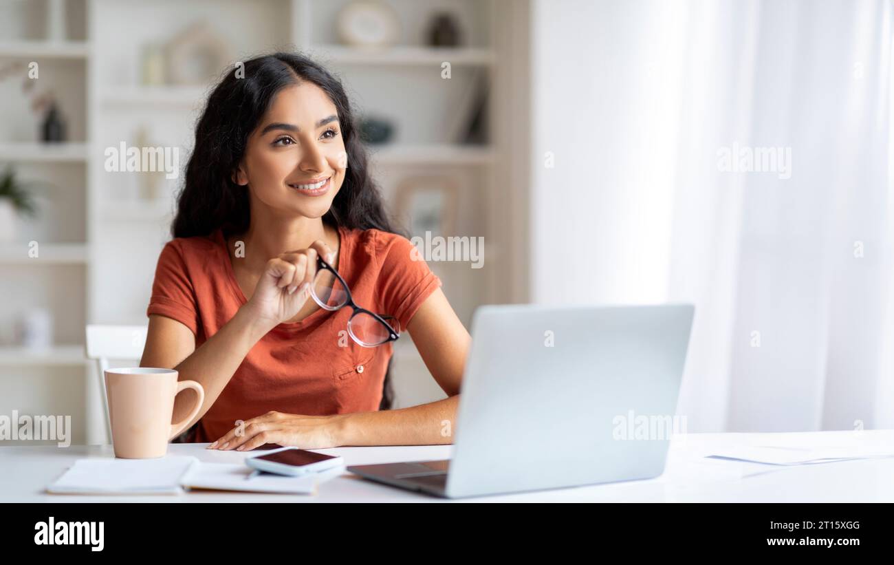Indian woman laptop thinking on hi-res stock photography and images - Alamy