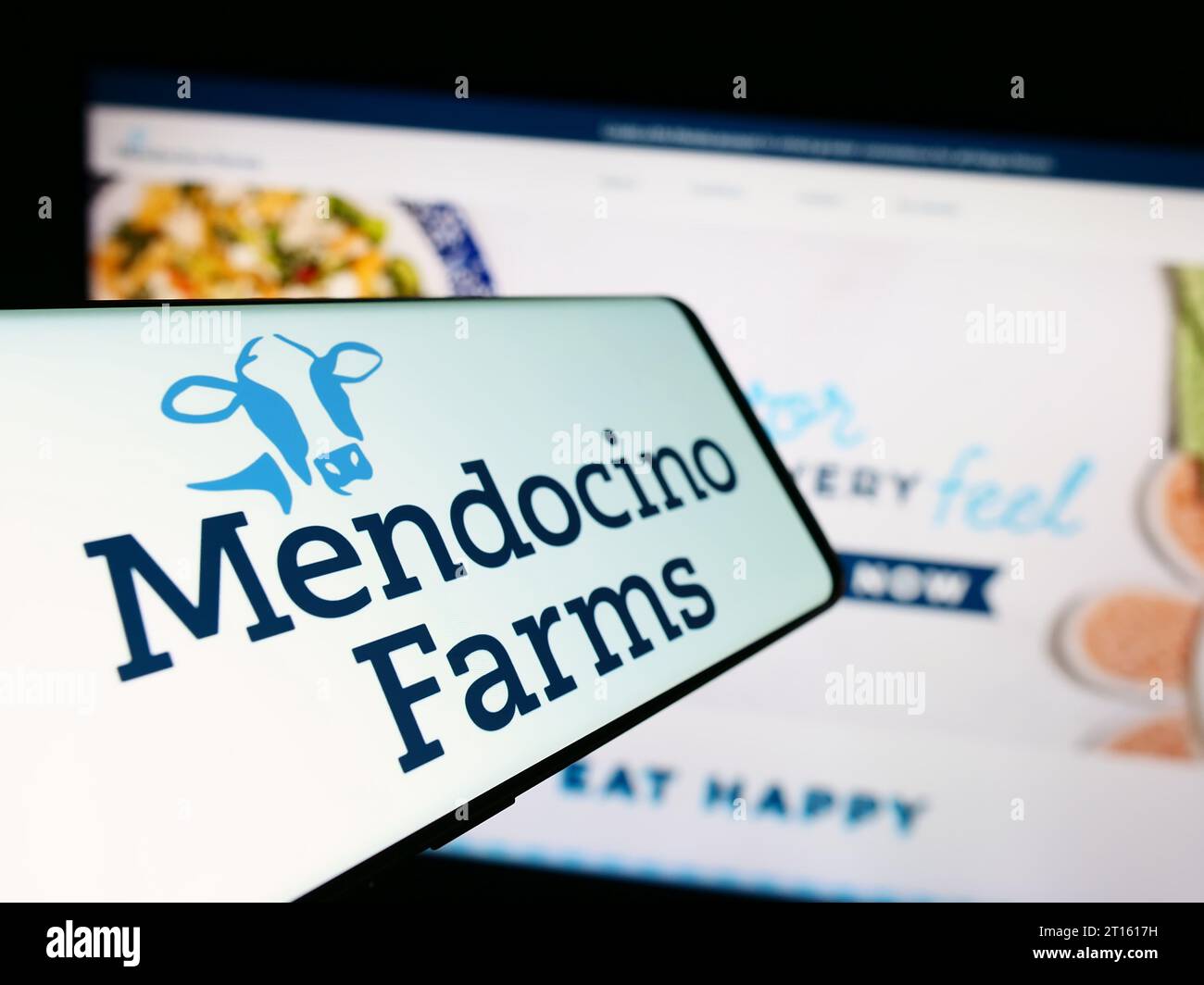 Cellphone with logo of American fast casual restaurant chain Mendocino Farms in front of company website. Focus on center-left of phone display. Stock Photo
