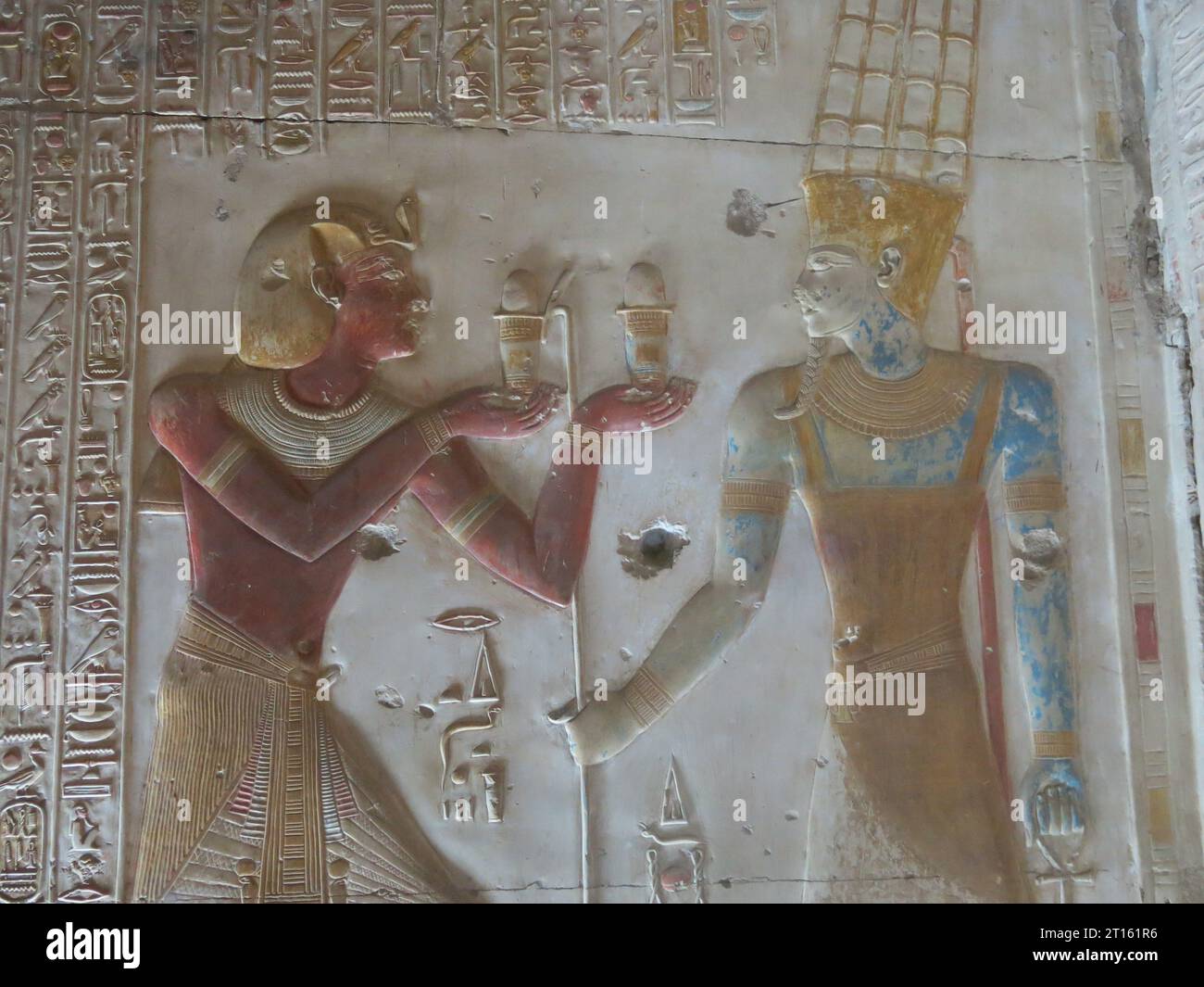 Colourful, carved reliefs in the Chapel of Osiris at the Great Temple of Seti I in Abydos, one of the oldest cities of Ancient Egypt. Stock Photo