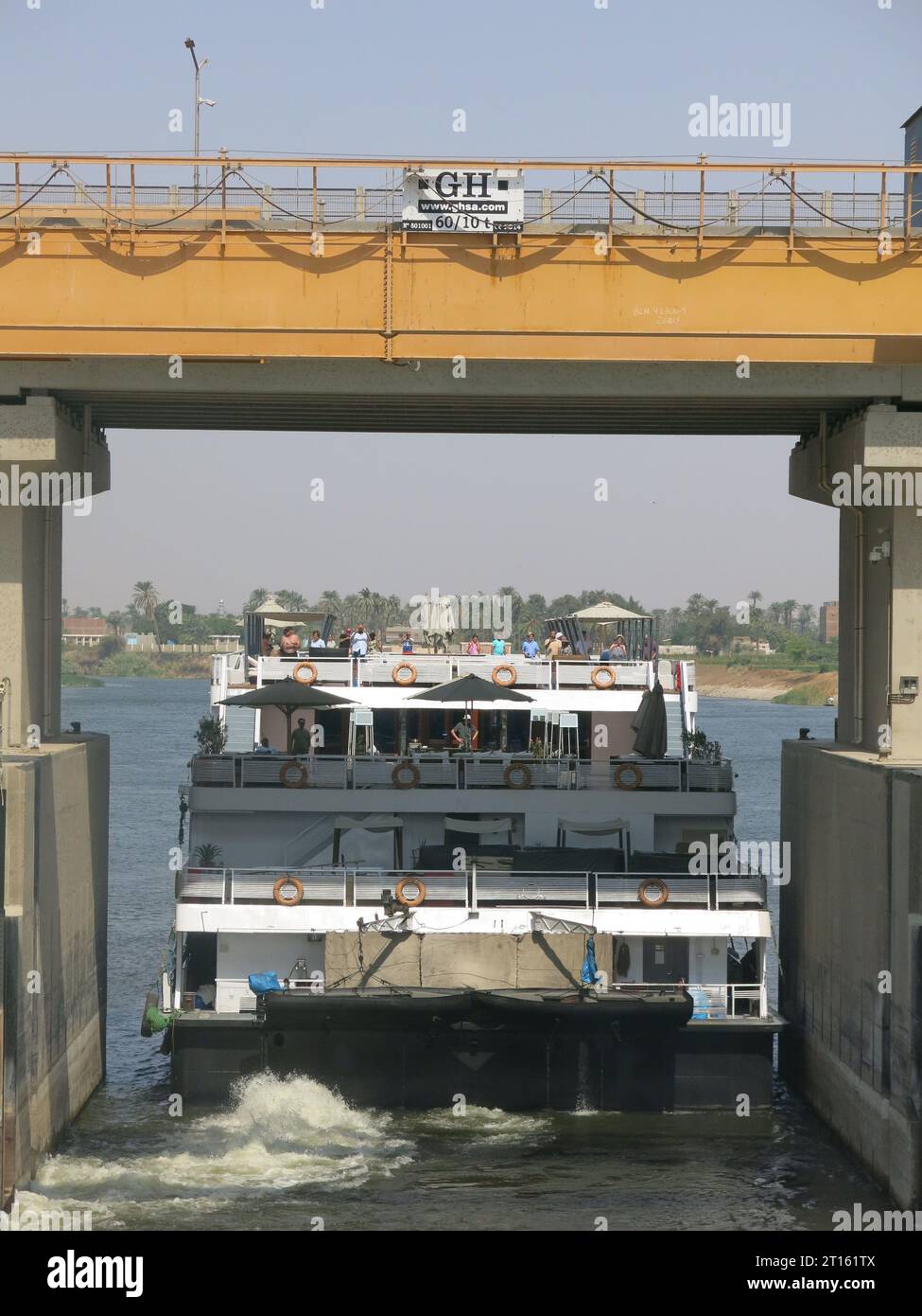 A cruise ship passes through one of the navigable locks at the new Assiut Barrage (Asyut Dam) north of Luxor, Egypt. Stock Photo