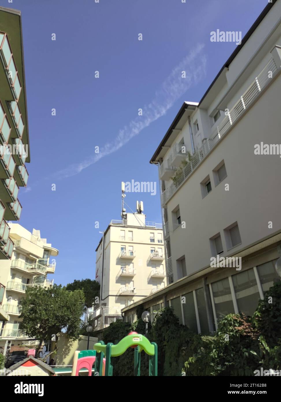 Two  buildings side by side with balconies by their sides on a sunny day Stock Photo