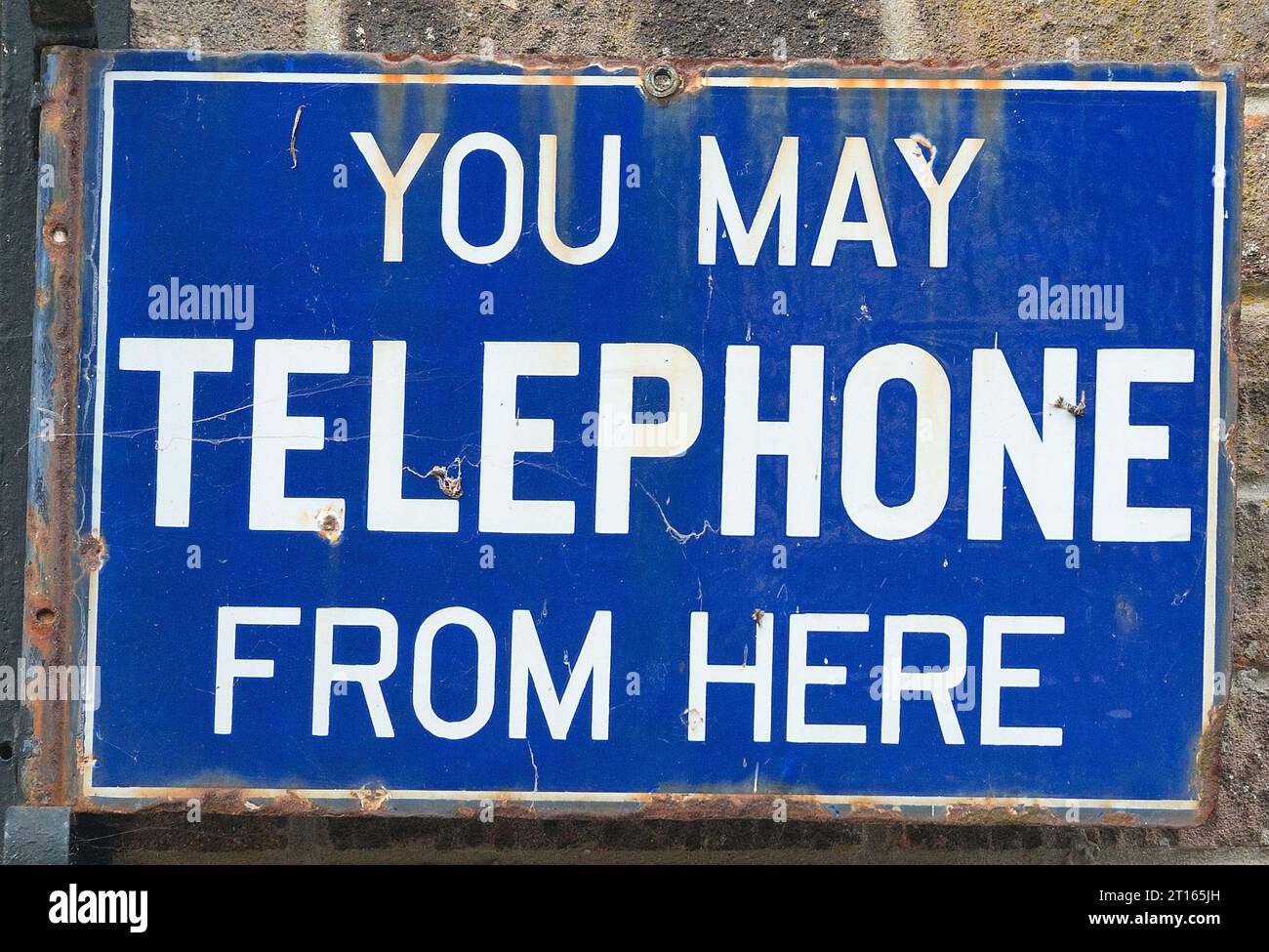 Old sign saying You May Telephone from Here Stock Photo