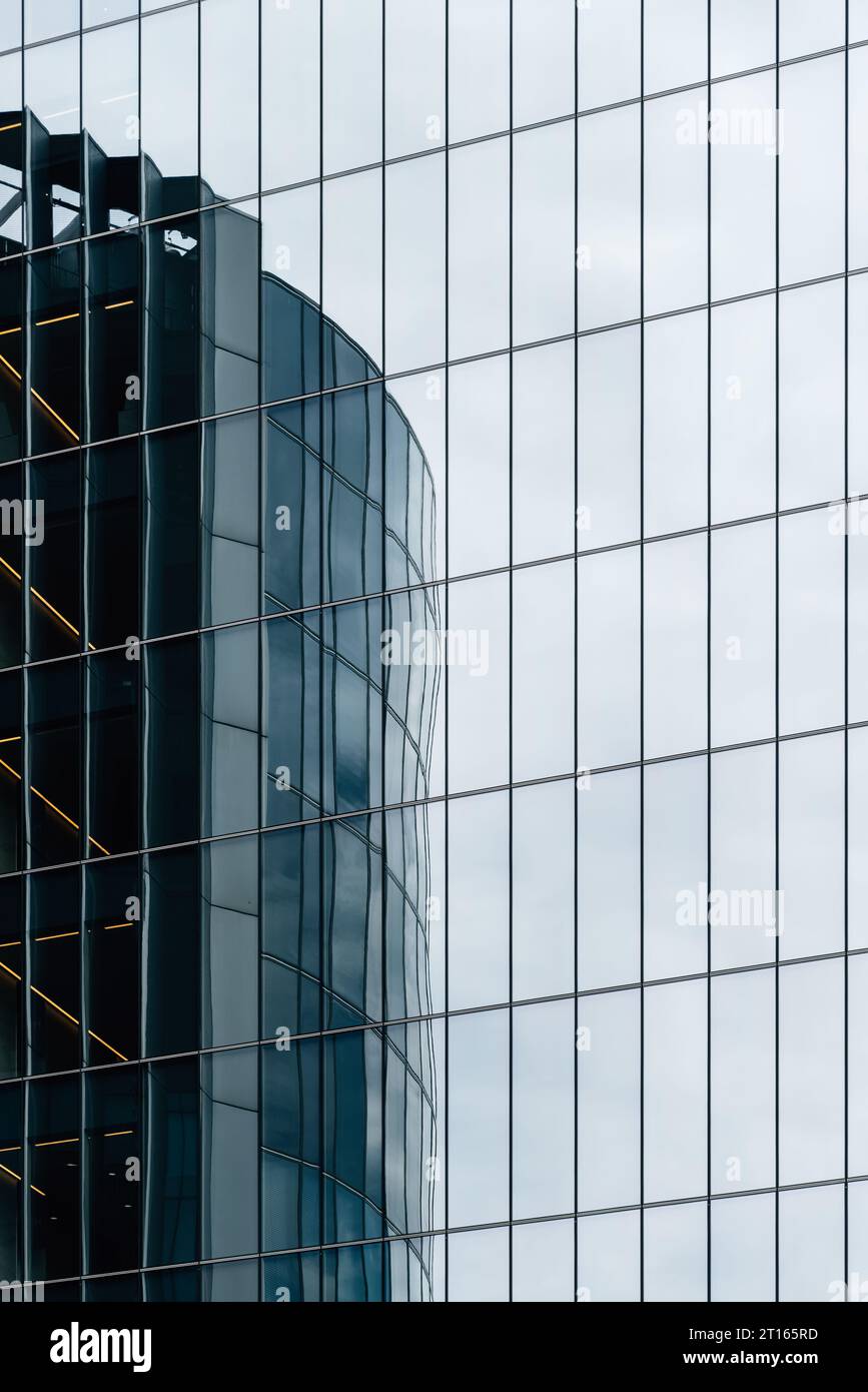 London, UK - August 25, 2023: Reflections on curtain wall glass facade of modern office skyscrapers in the City of London. Stock Photo