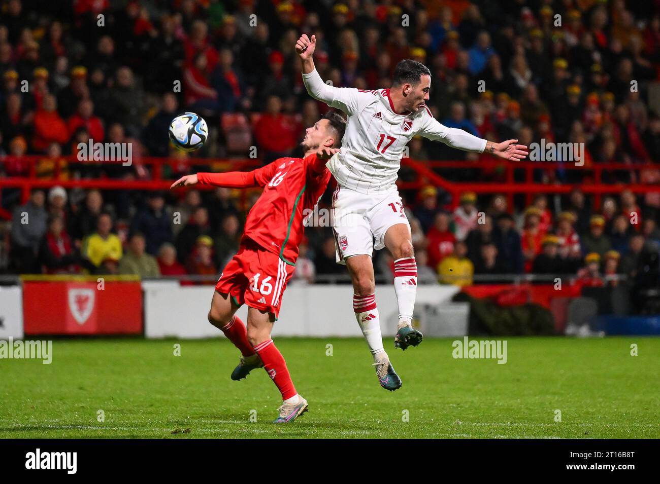 Liam Cullen of Wales and Kian Ronan of Gibraltar battle for the ball during the International Friendly match Wales vs Gibraltar at SToK Cae Ras, Wrexham, United Kingdom, 11th October 2023  (Photo by Craig Thomas/News Images) Stock Photo