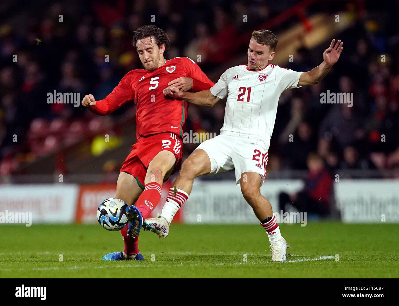 Wales' Tom Lockyer and Gibraltar's James Coombes (right) battle for the ball during an international friendly match at the SToK Racecourse, Wrexham. Picture date: Wednesday October 11, 2023. Stock Photo