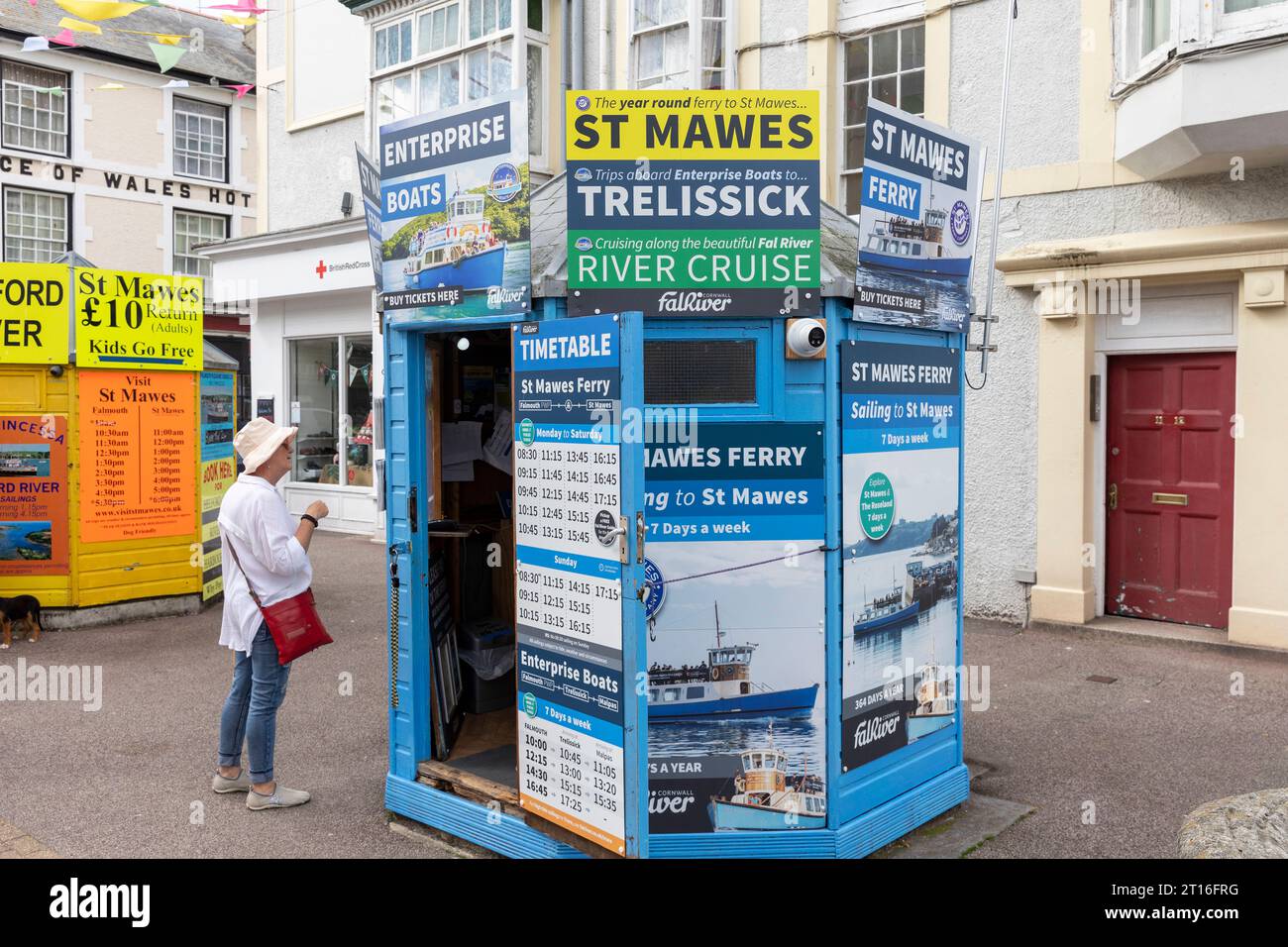 Falmouth Pier Cornwall, model released woman browsing boat and ferry trips from Falmouth,England,UK,September 2023 Stock Photo