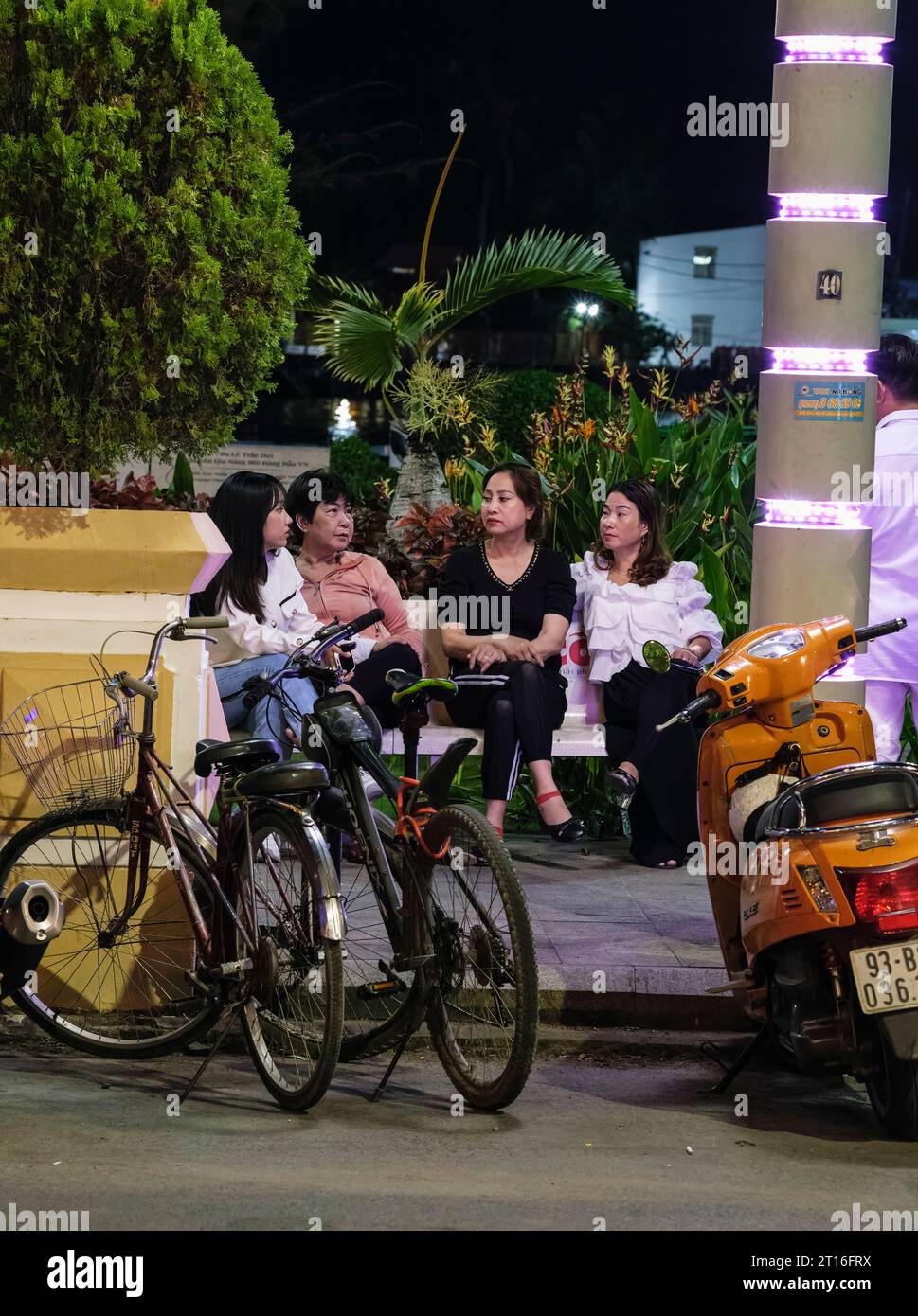 Can Tho, Vietnam. Women Resting on Hai Ba Trung Street, Early Evening. Stock Photo