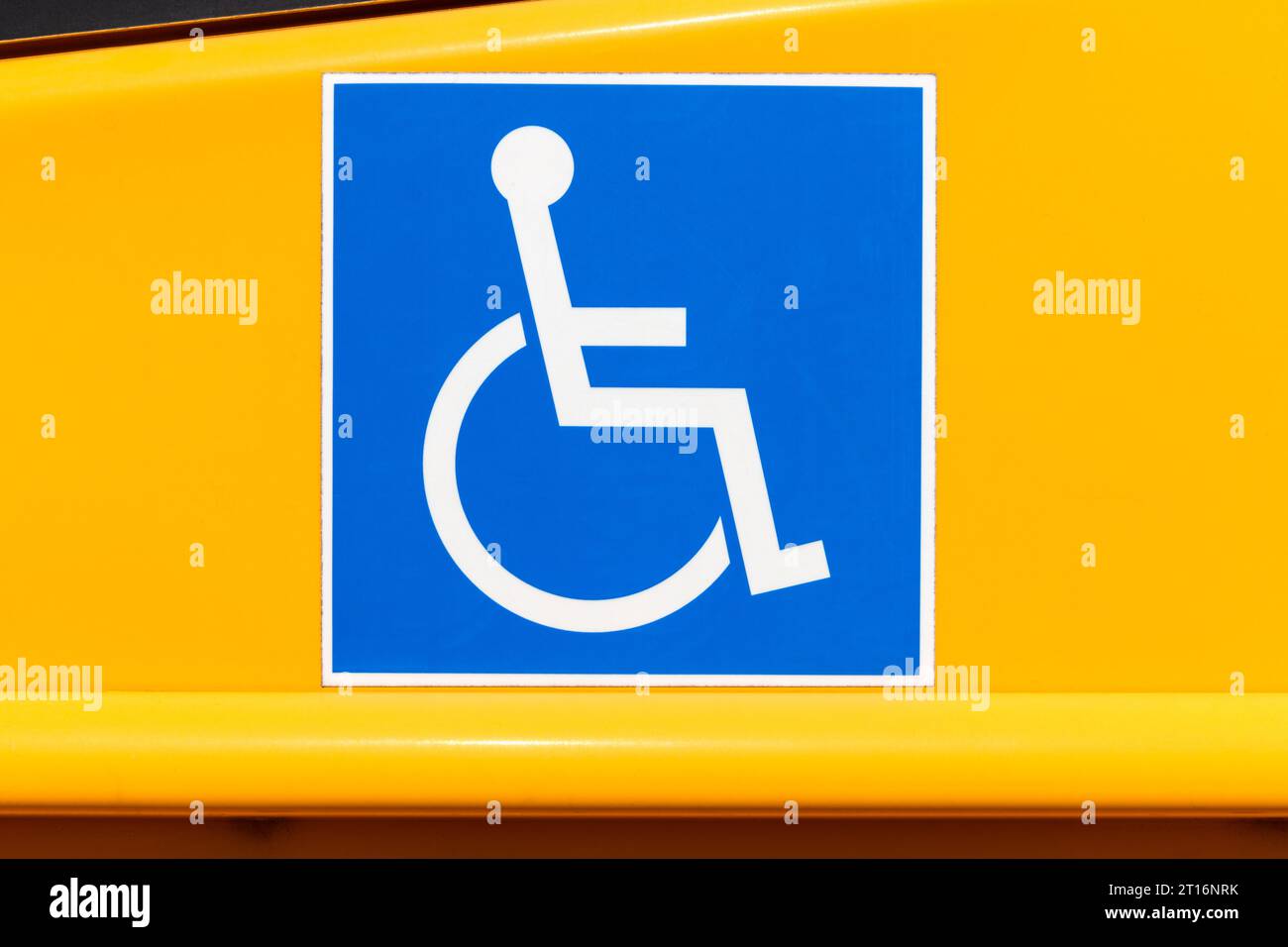 Handicapped wheelchair access logo sign on a yellow school bus. Stock Photo