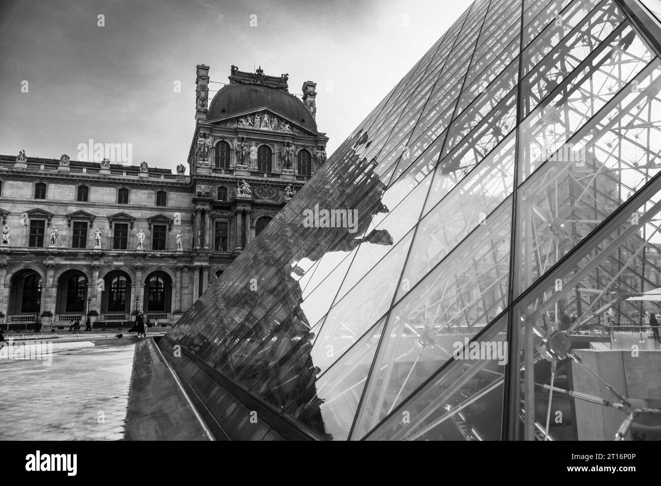 Courtyard and glass pyramid of the Louvre Museum at dusk, Paris, France Stock Photo