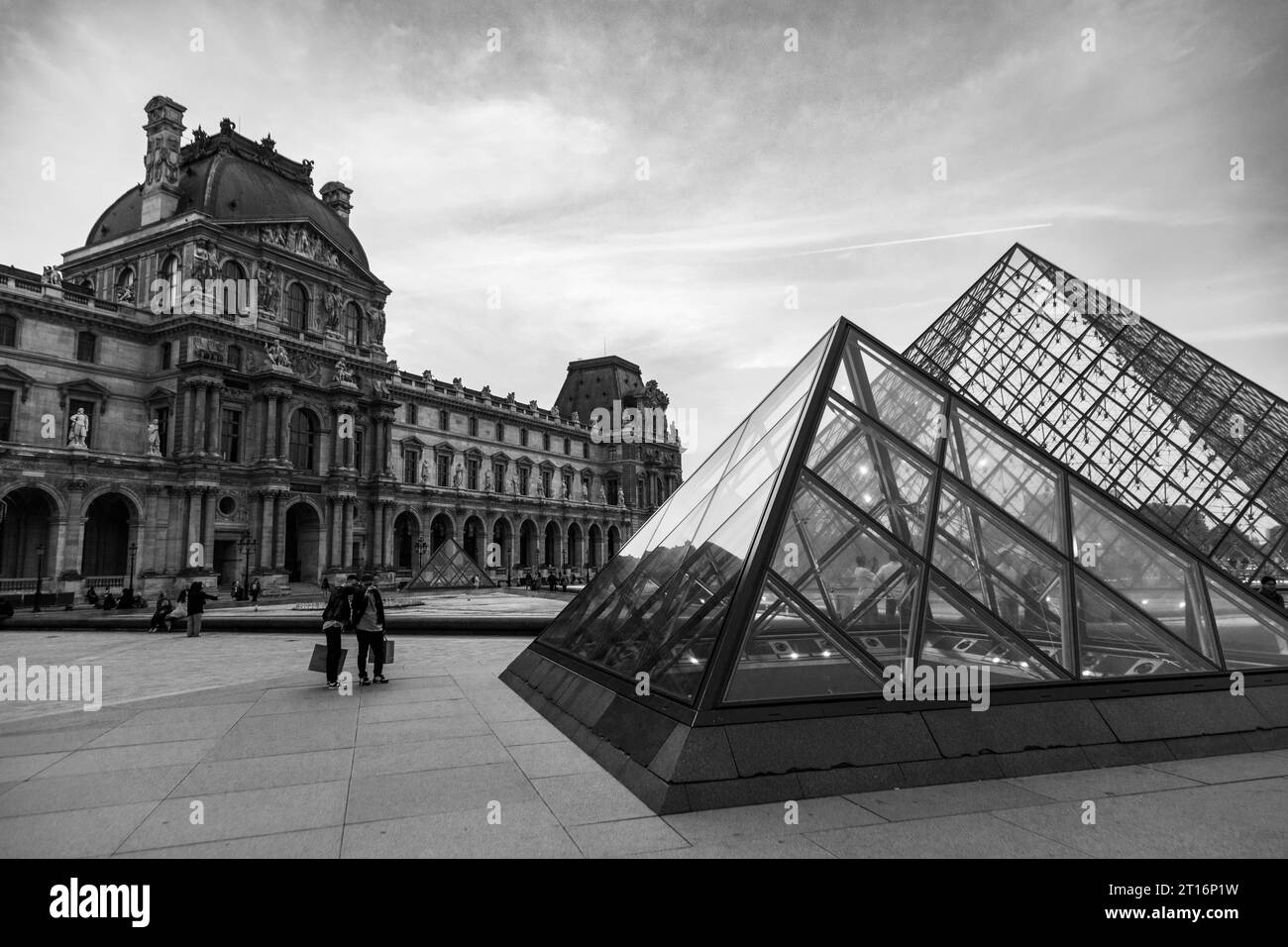 Courtyard and glass pyramid of the Louvre Museum at dusk, Paris, France Stock Photo