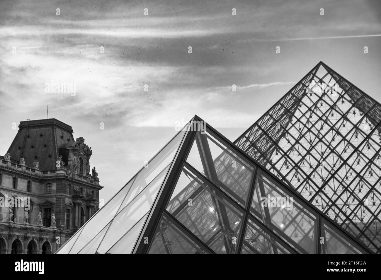 Courtyard and glass pyramid of the Louvre Museum at dusk, Paris, France Stock Photo