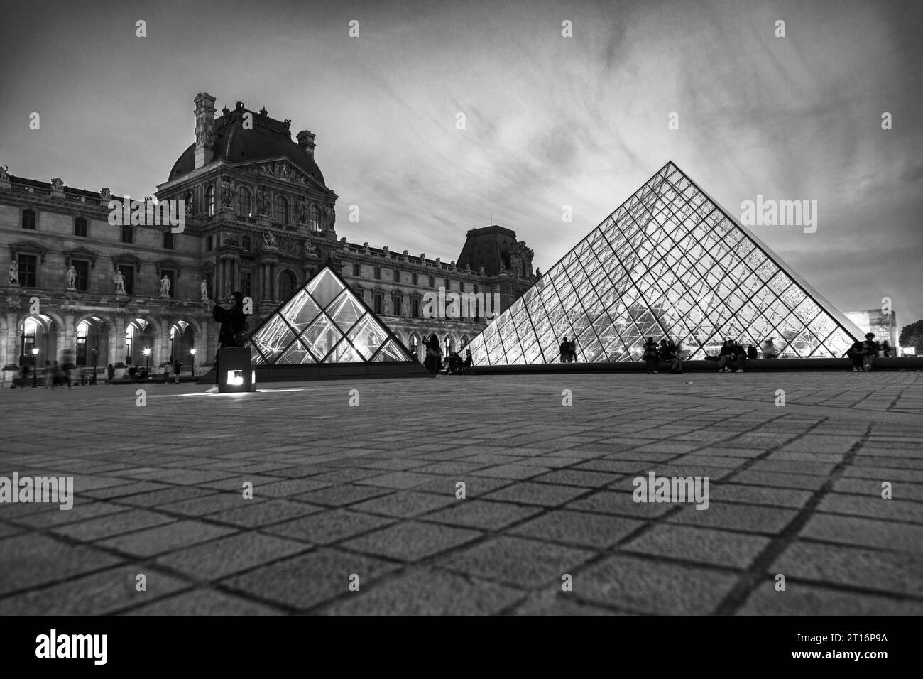 Courtyard and glass pyramid of the Louvre Museum at dusk, Paris, France