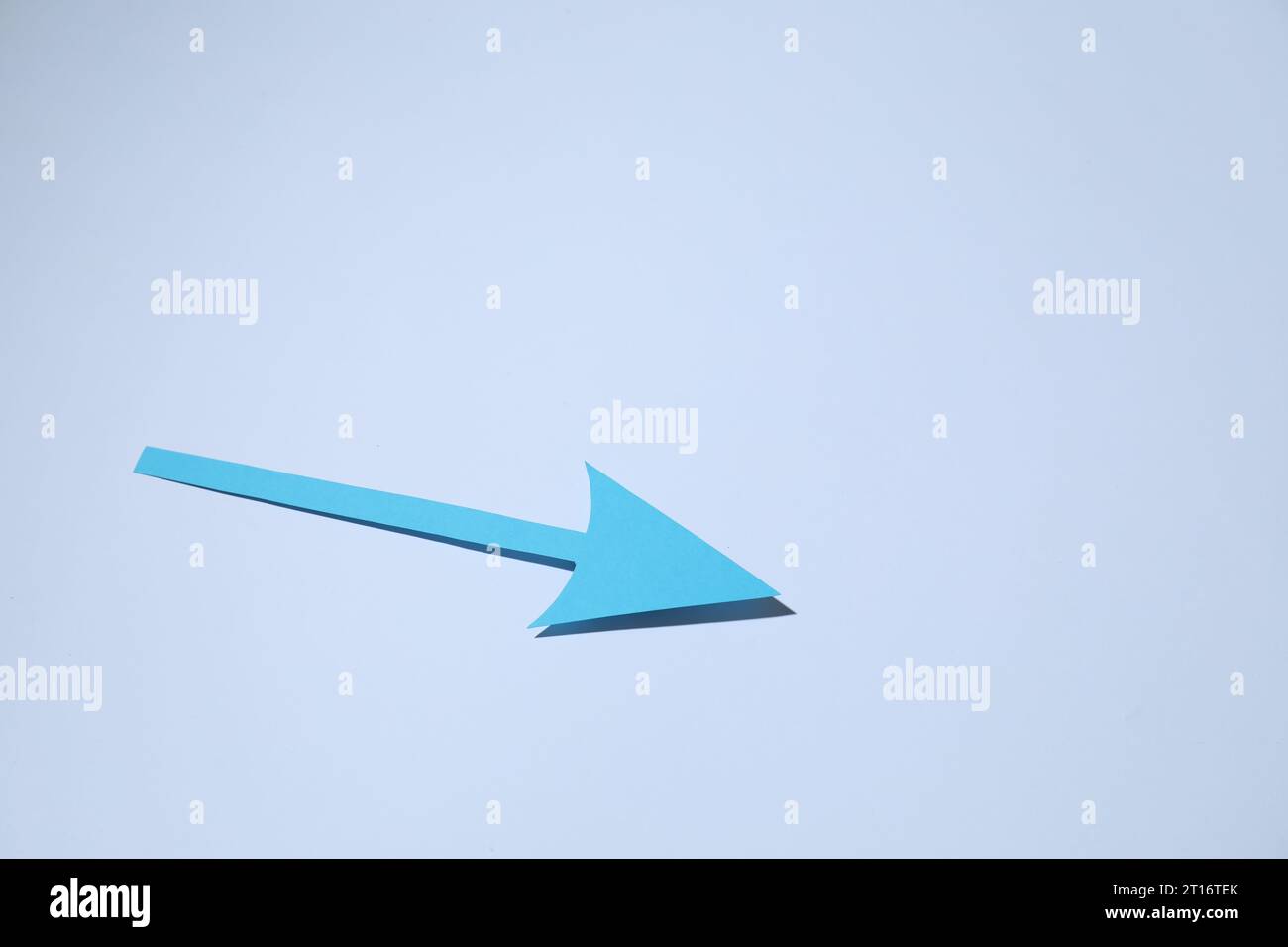 Light blue paper arrow on white background, space for text Stock Photo ...
