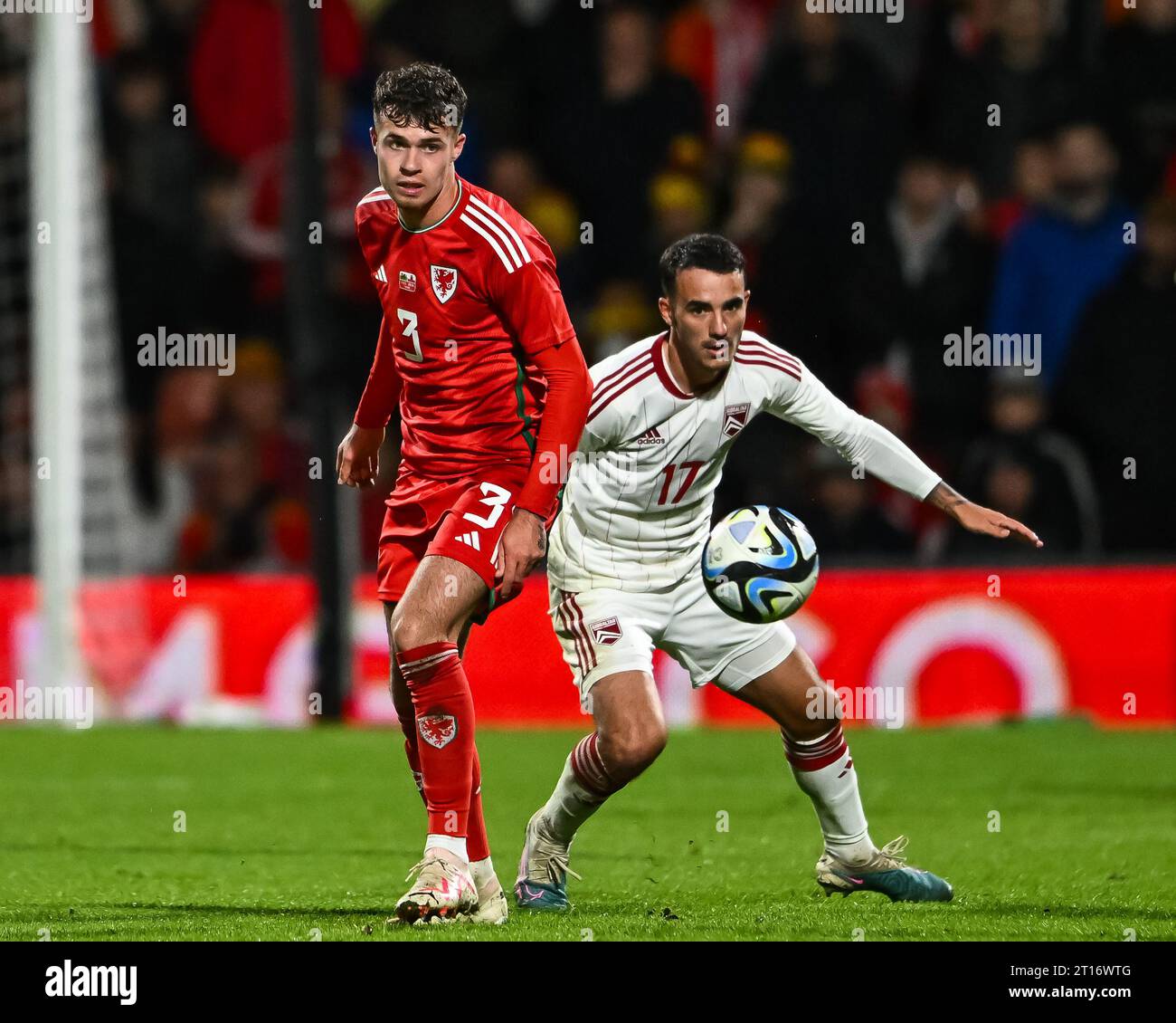 Neco Williams of Wales and Kian Ronan of Gibraltar battle for the ball during the International Friendly match Wales vs Gibraltar at SToK Cae Ras, Wrexham, United Kingdom, 11th October 2023  (Photo by Craig Thomas/News Images) Stock Photo