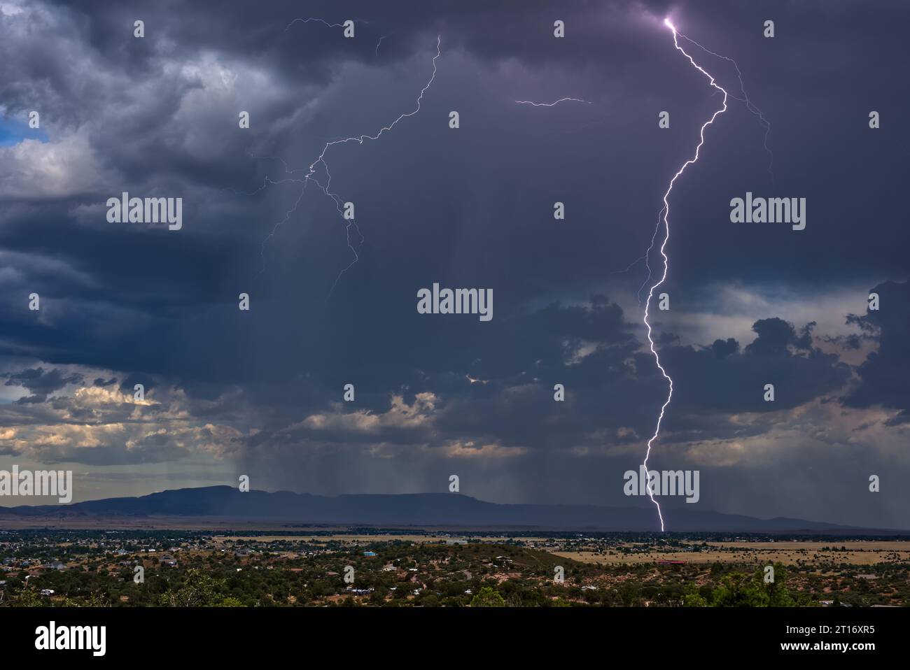Lightning storm over Chino Valley Arizona during the 2023 Monsoon season. In the background is Mingus Mountain. This lightning strike was captured wit Stock Photo