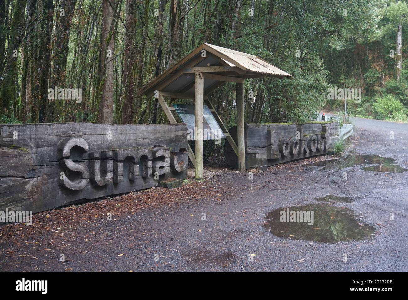 Carved wooden Sumac Lookout sign on a rainy day on the tourist drive