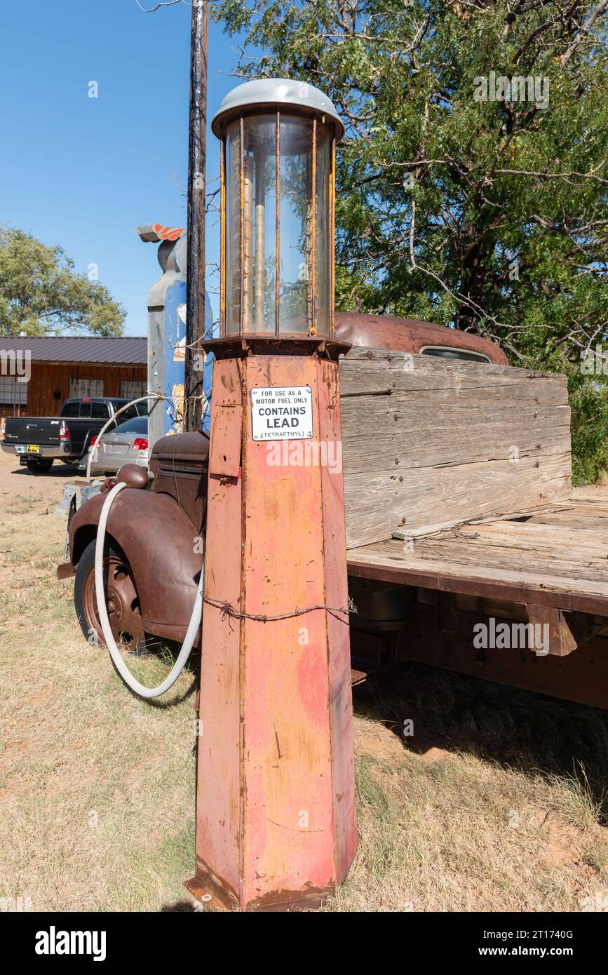 A tall vintage, rusty, hand crank gas pump with a clear gas cylinder in Tucumcari, New Mexico, United States. Stock Photo