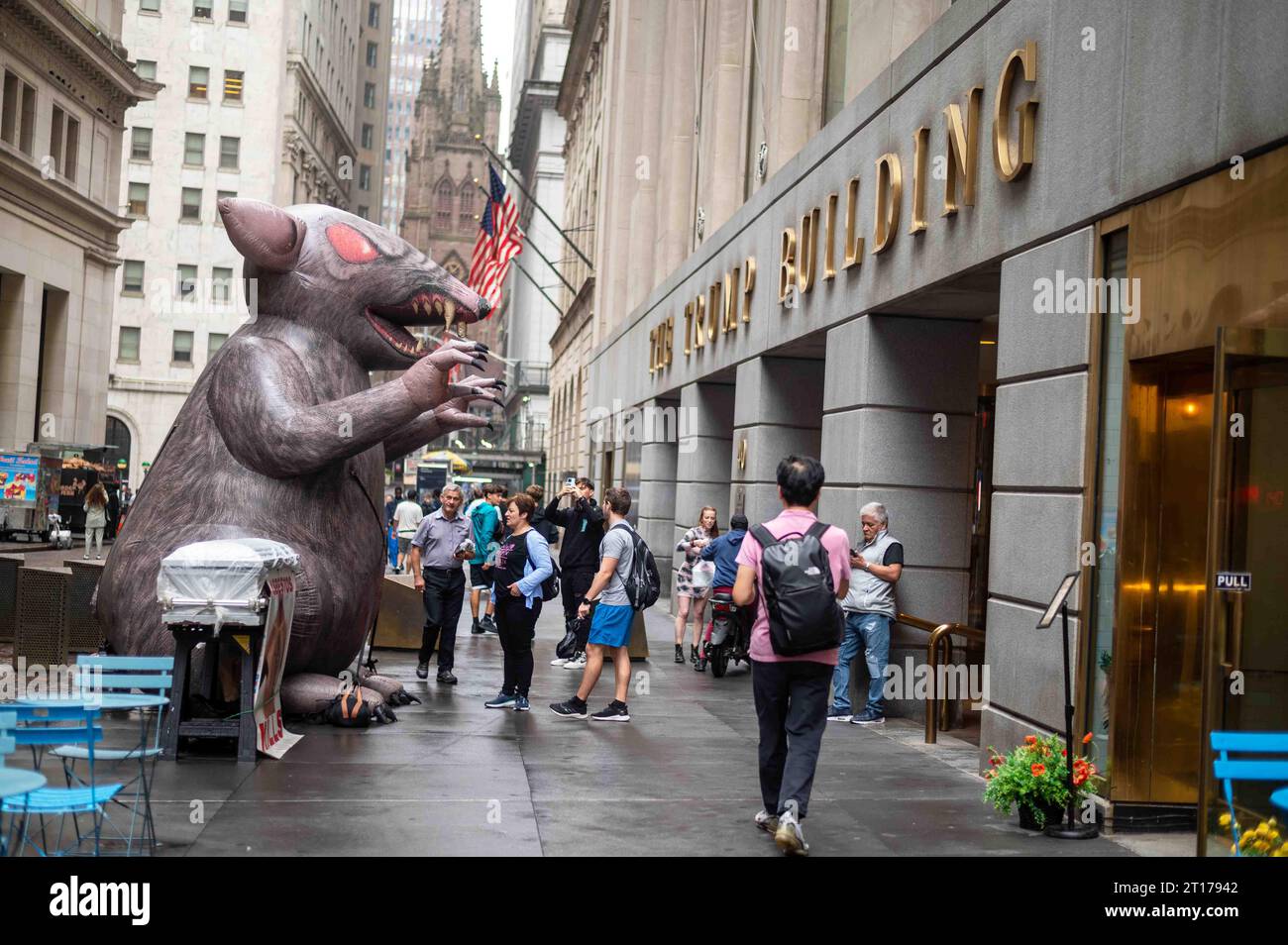 Giant inflatable rat in front of Trump Building Manhattan NY side view
