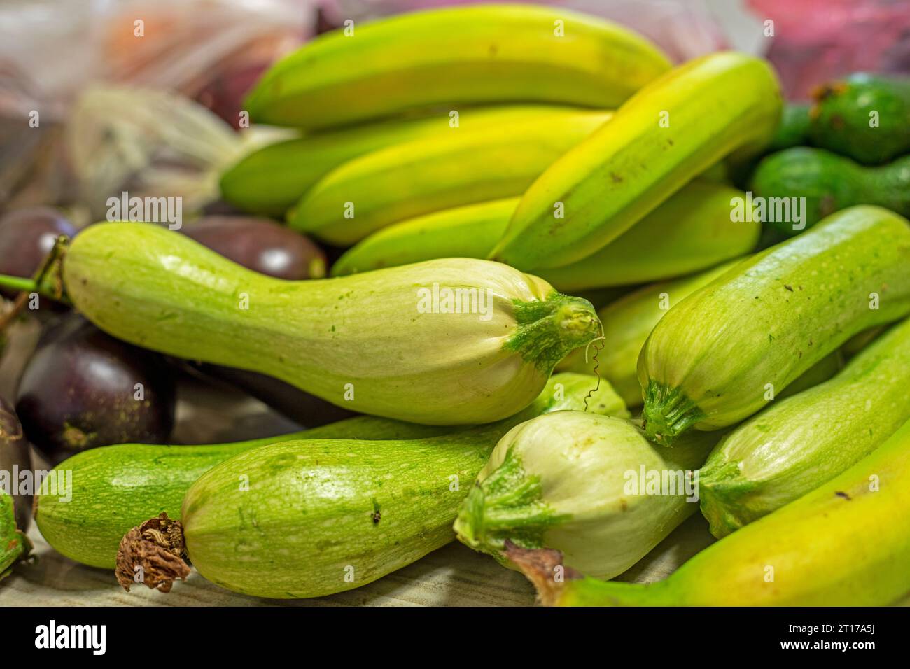 green bananas lie next to green zucchini Stock Photo - Alamy