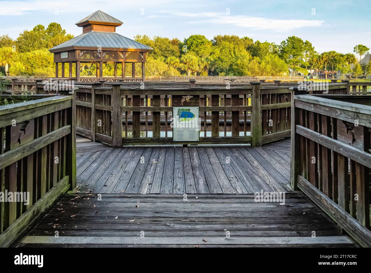 Rookery viewing area and waterfront boardwalk with a running squirrel on the railing at Bird Island Park in Ponte Vedra Beach, Florida. (USA) Stock Photo