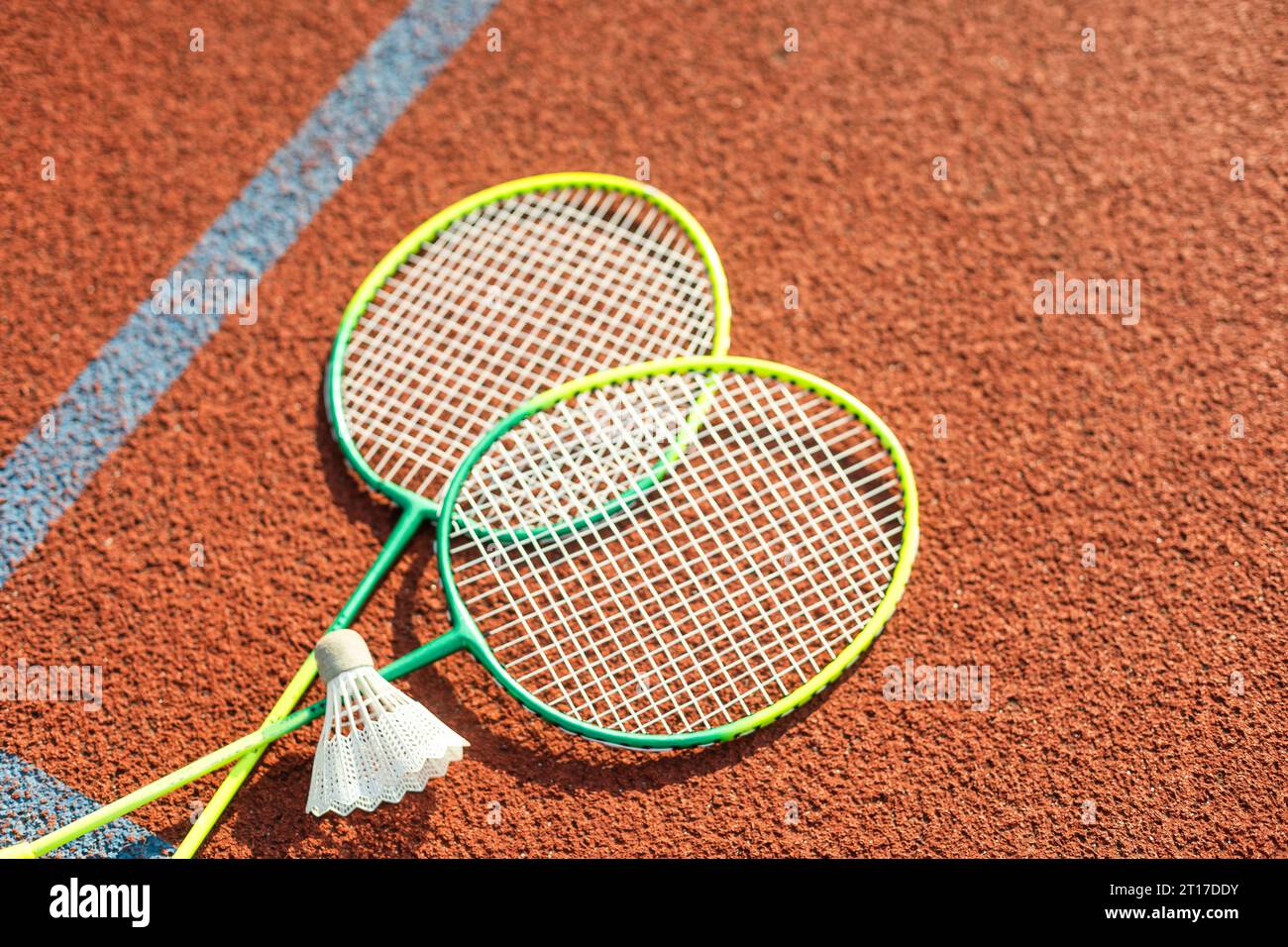 Badminton rackets and feather shuttlecock on the court Stock Photo - Alamy