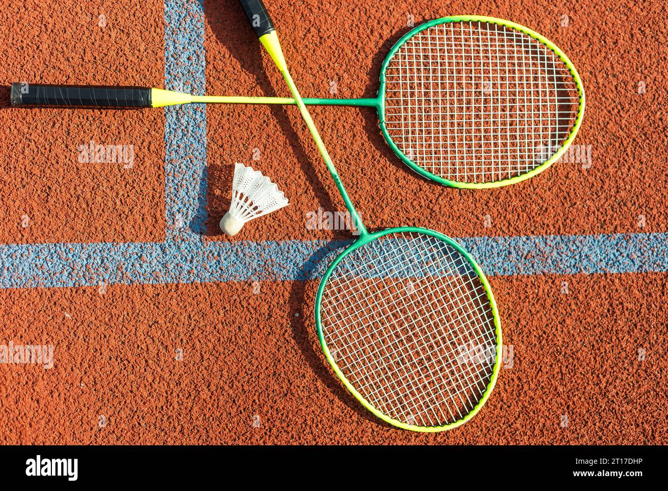 Badminton rackets and feather shuttlecock on the court Stock Photo - Alamy