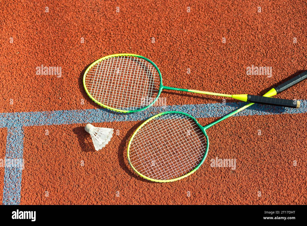 Badminton rackets and feather shuttlecock on the court Stock Photo - Alamy