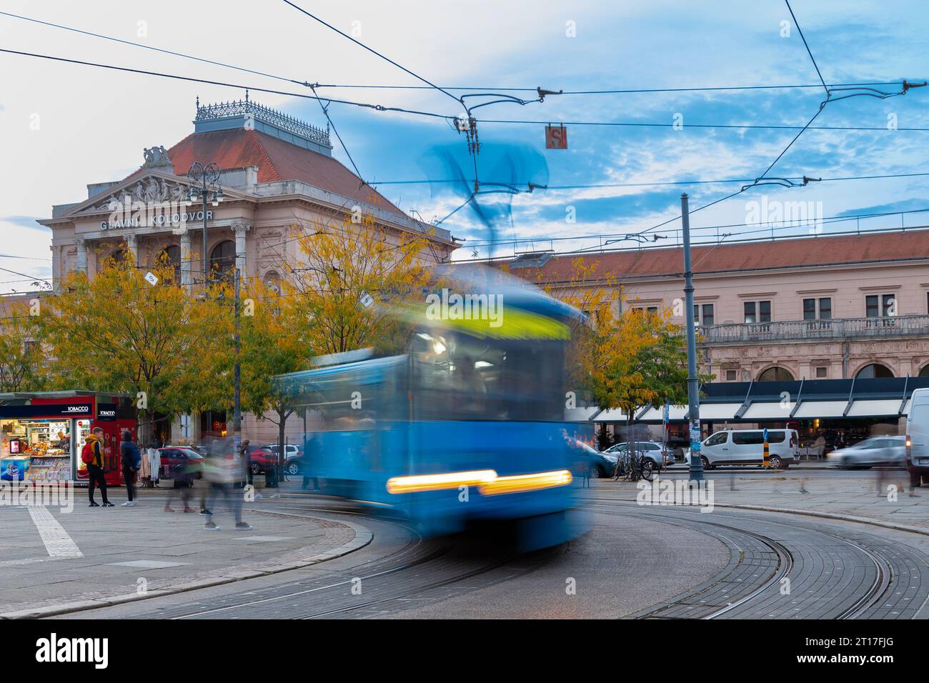 The central square with the typical blue tram in front of the Glavni Kolod train station in Zagreb. It is the largest station in Croatia and the main Stock Photo