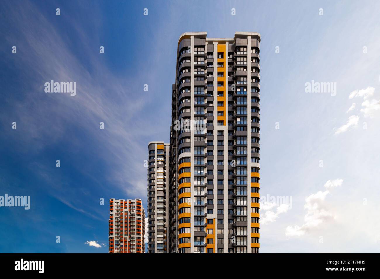 freshly built high rise apartment buildings on blue sky background with ...