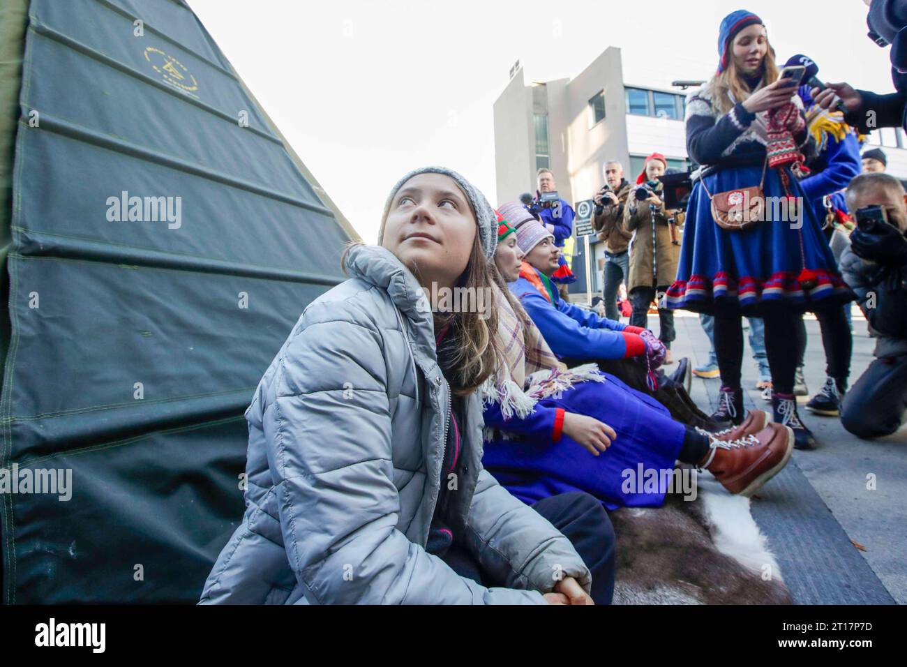 Environmental activist Greta Thunberg, left, joins activists wearing a ...