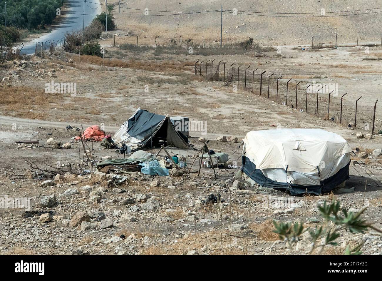 Bedouin houses in the desert near Dead Sea. Poor regions of the world. A indigent Bedouin sitting at the tent. Poverty in Jordan. middle East Stock Photo