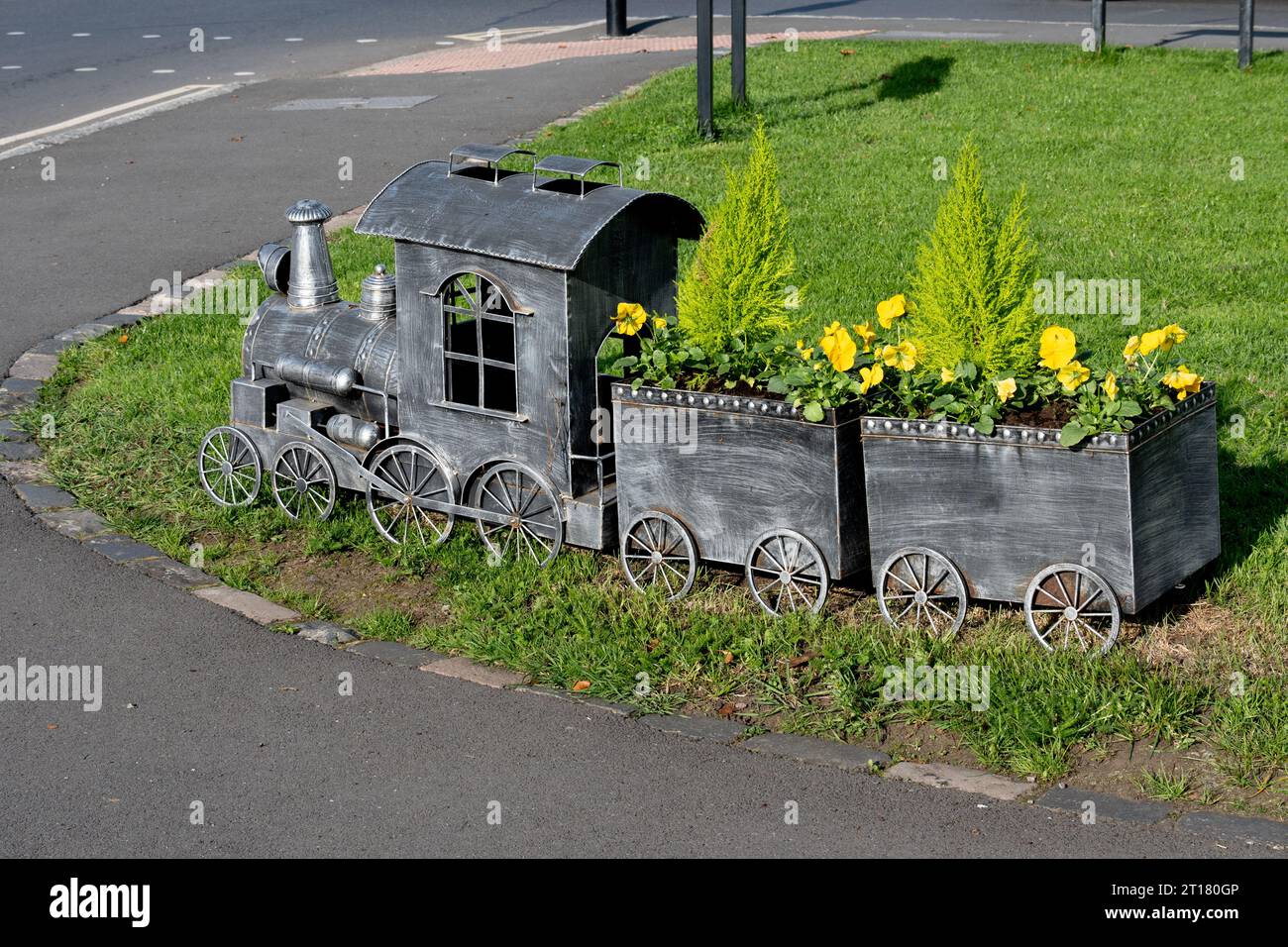 Model train planter in Dunchurch village centre, Warwickshire, England, UK Stock Photo