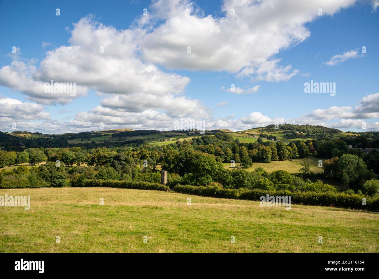 Hills around Bollington east of Macclesfield, Cheshire, England. An old chimney seen above the trees. Stock Photo