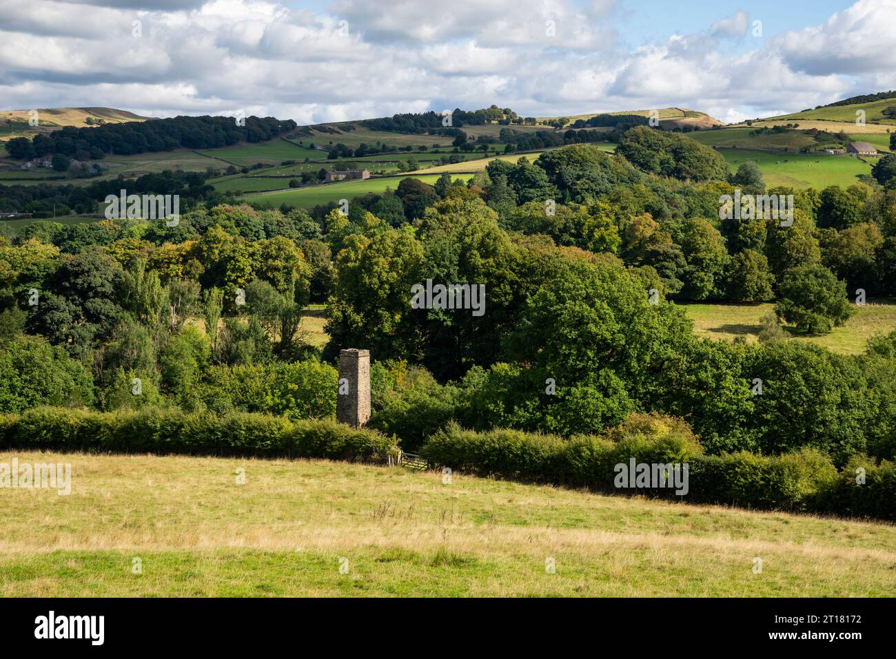 Hills around Bollington east of Macclesfield, Cheshire, England. An old chimney seen above the trees. Stock Photo