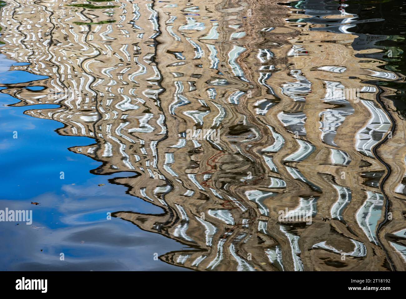 Old mill beside the Macclesfield canal, Cheshire, England, reflected in the water. Stock Photo