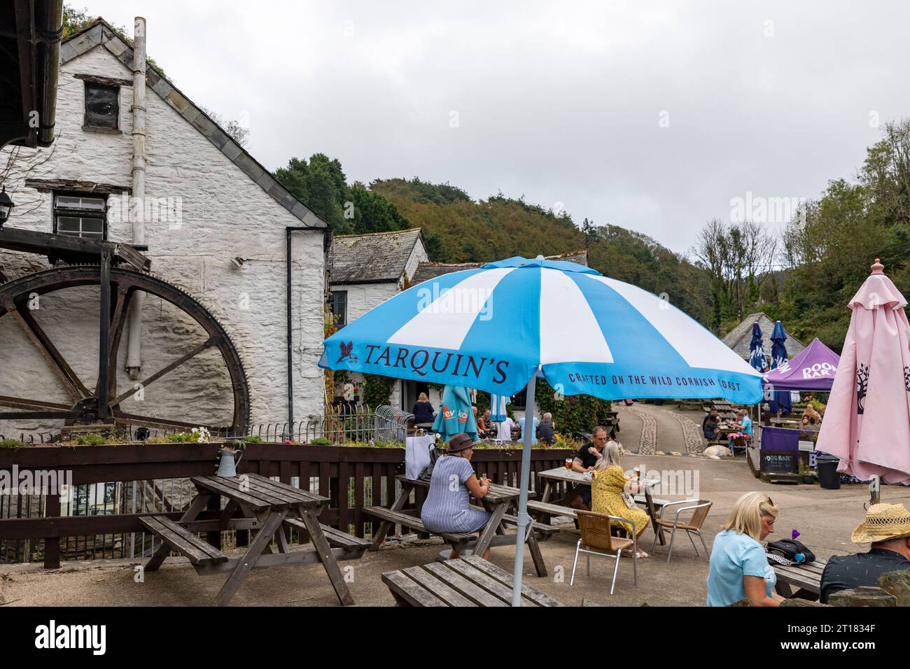 The Crumplehorn Inn & Mill in Polperro village,Cornwall,England,UK taken September 2023, people sitting outside drinking and eating Stock Photo