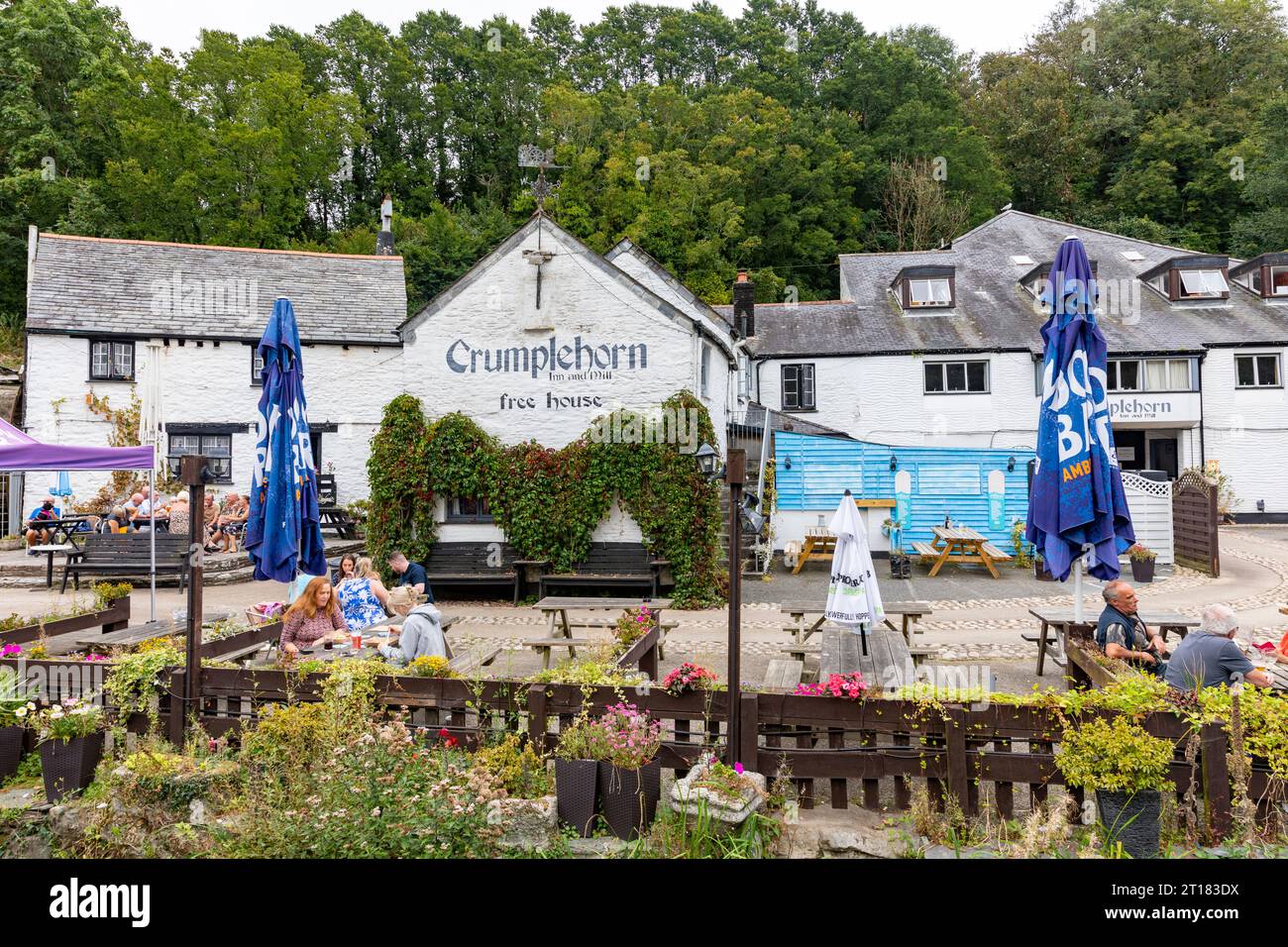 The Crumplehorn Inn & Mill in Polperro village,Cornwall,England,UK taken September 2023, people sitting outside drinking and eating Stock Photo