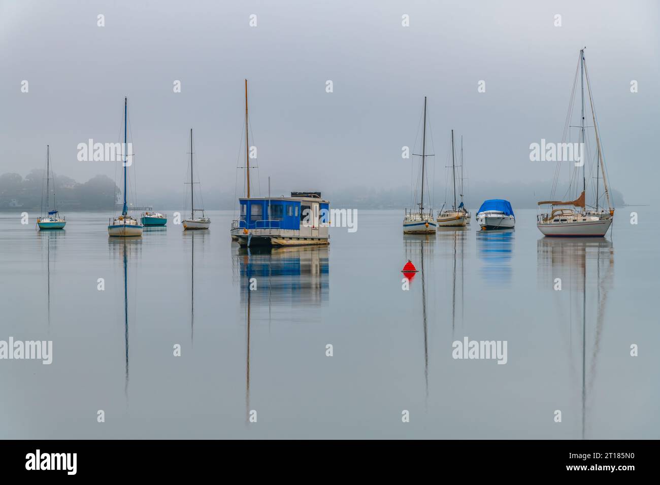 Foggy Sunrise with boats on Brisbane Water at Koolewong and Tascott on the Central Coast, NSW, Australia. Stock Photo