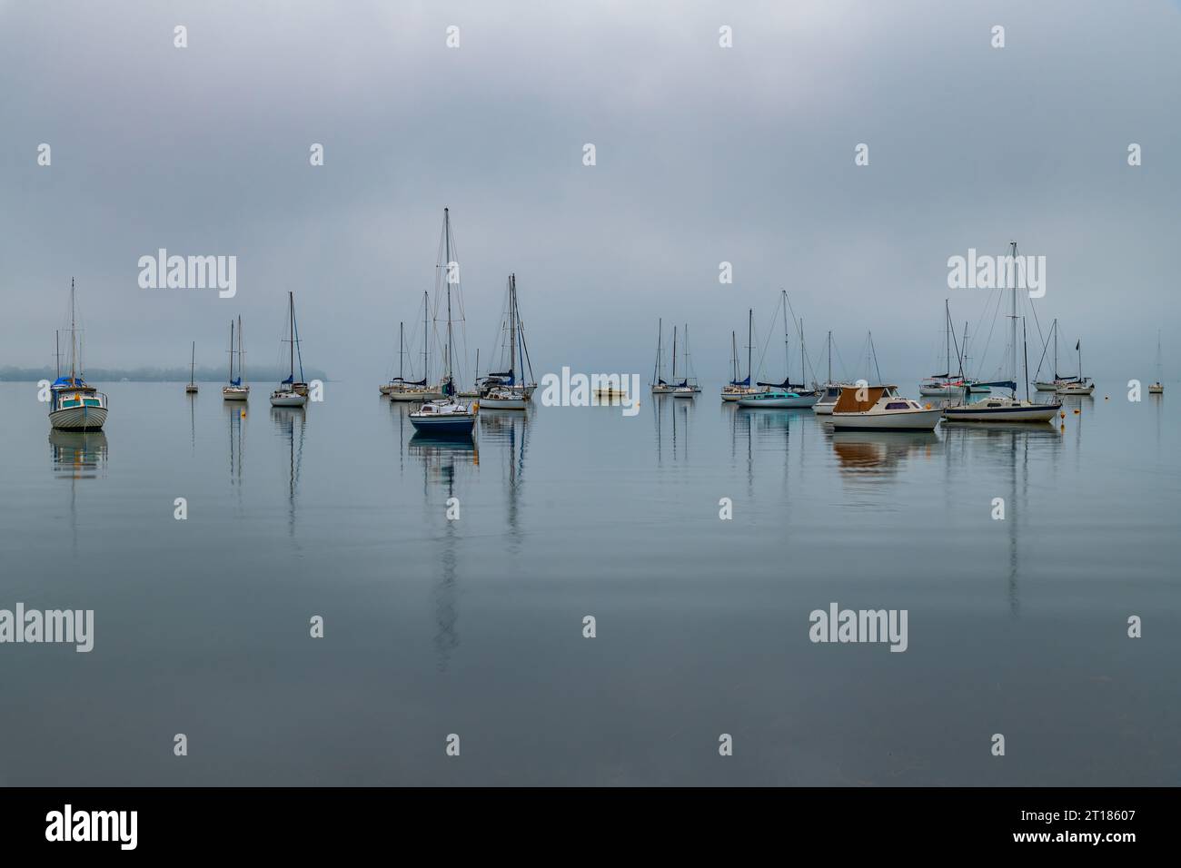 Foggy Sunrise with boats on Brisbane Water at Koolewong and Tascott on the Central Coast, NSW, Australia. Stock Photo